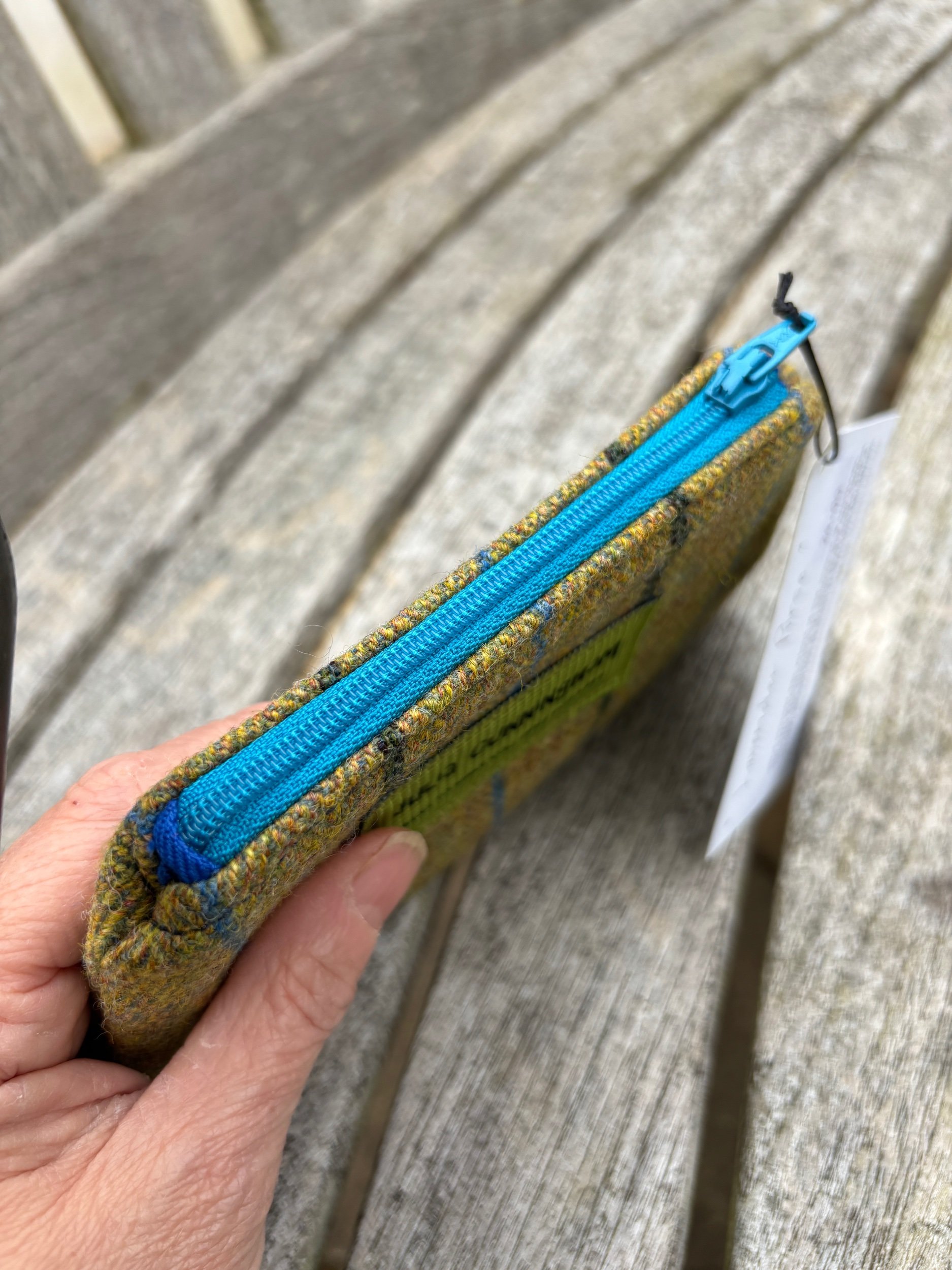 Close‑up of striped Scottish tweed fabric showing zip