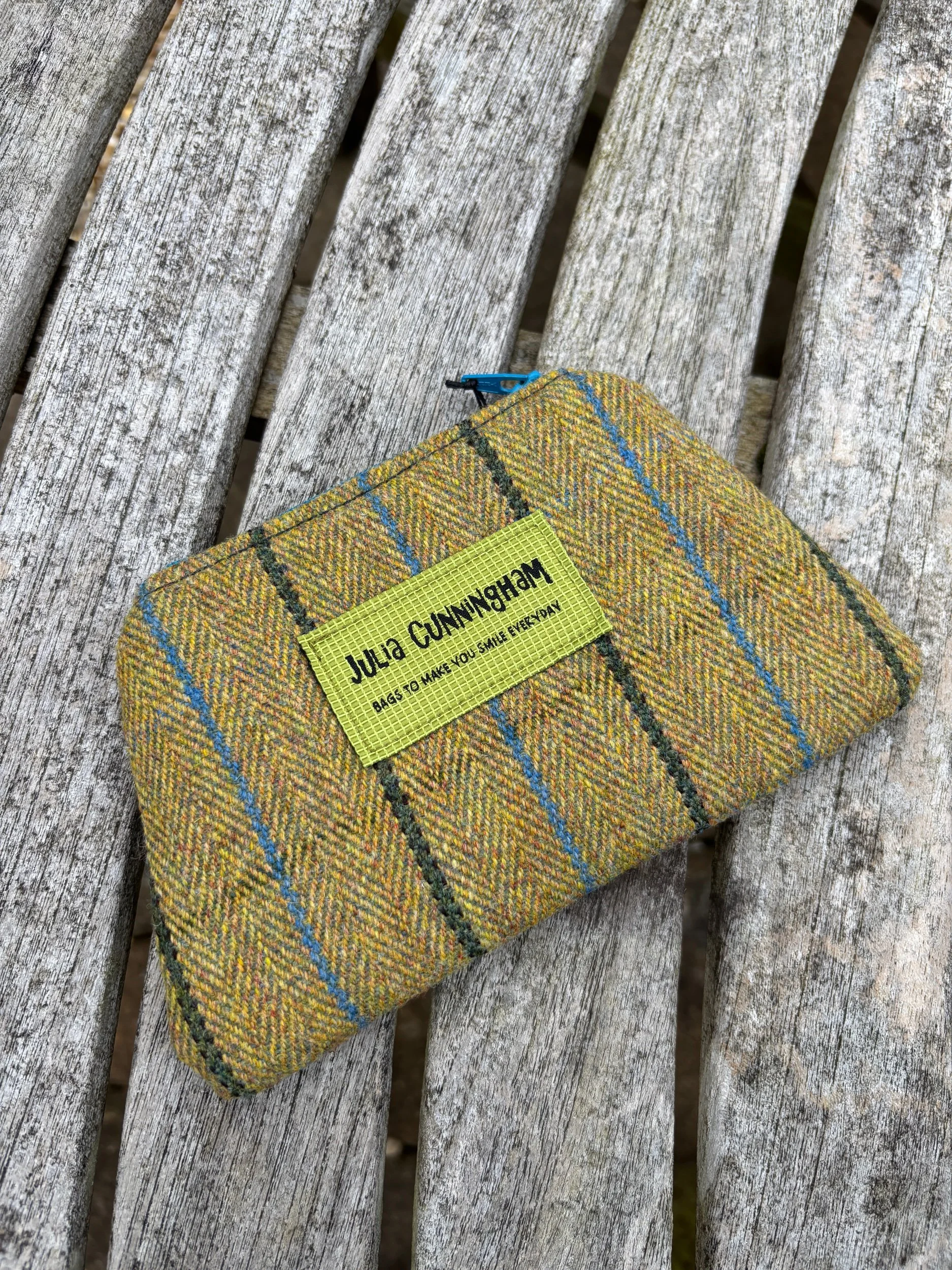 Front view of striped traditional tweed zip pouch filled with natural lavender.
