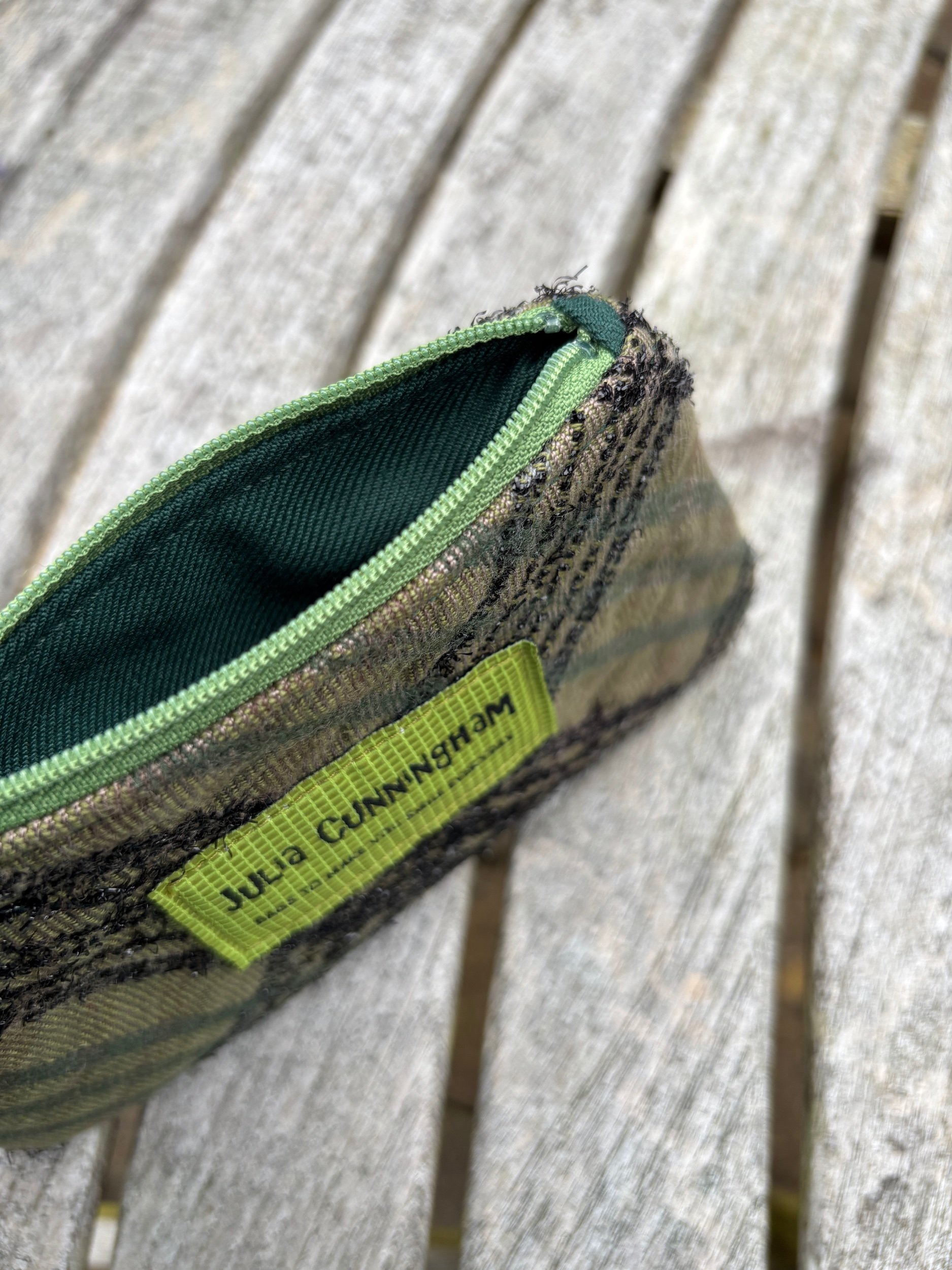 Interior view of the handmade green Lochcarron tweed lavender purse showing the soft lining and Yorkshire lavender filling.