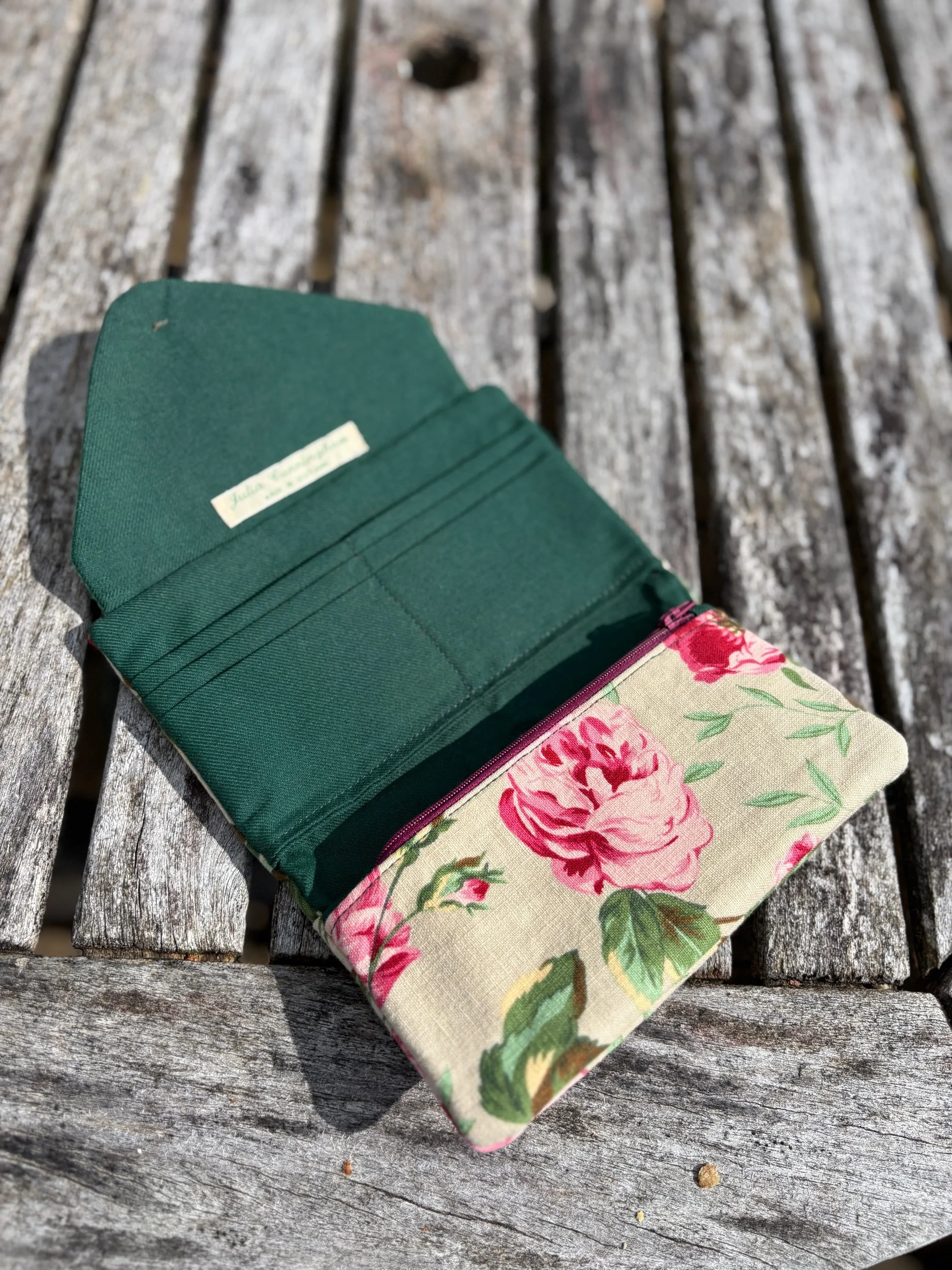 Close‑up of floral linen fabric texture on handmade upcycled clutch bag