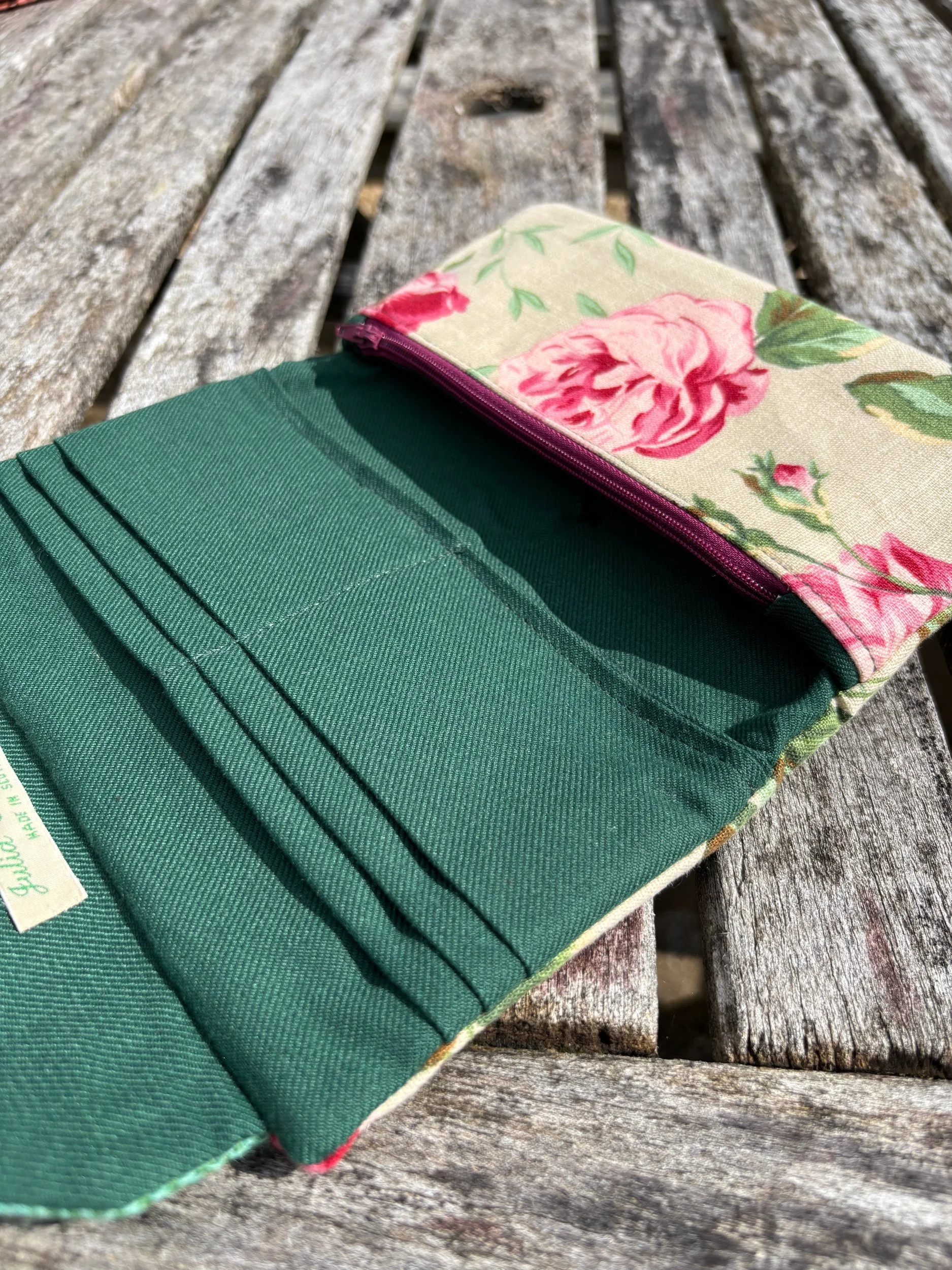 Inside view of handmade clutch bag showing lining, pockets, and internal layout