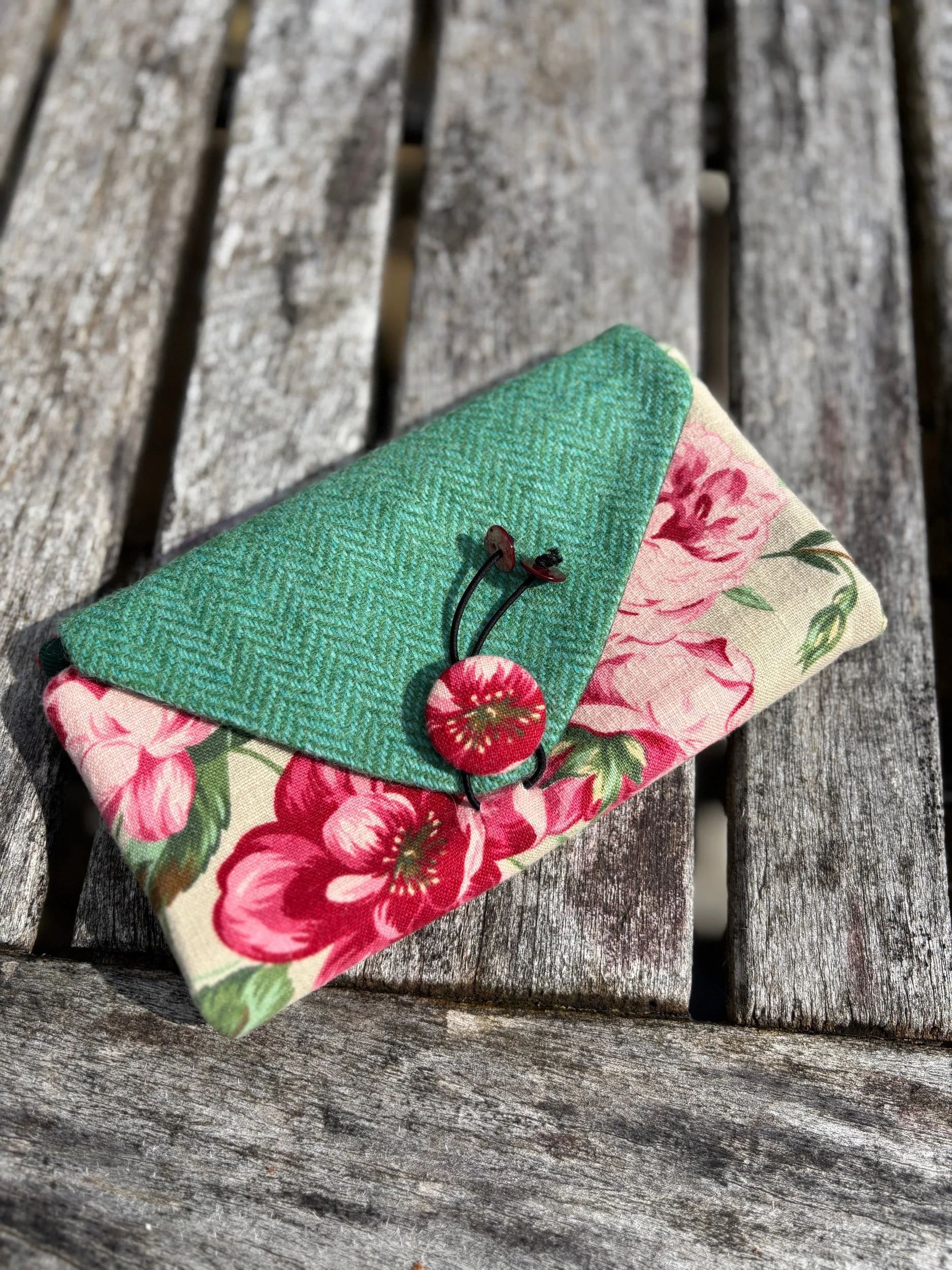 Front view of handmade upcycled floral linen clutch bag with Scottish tweed flap