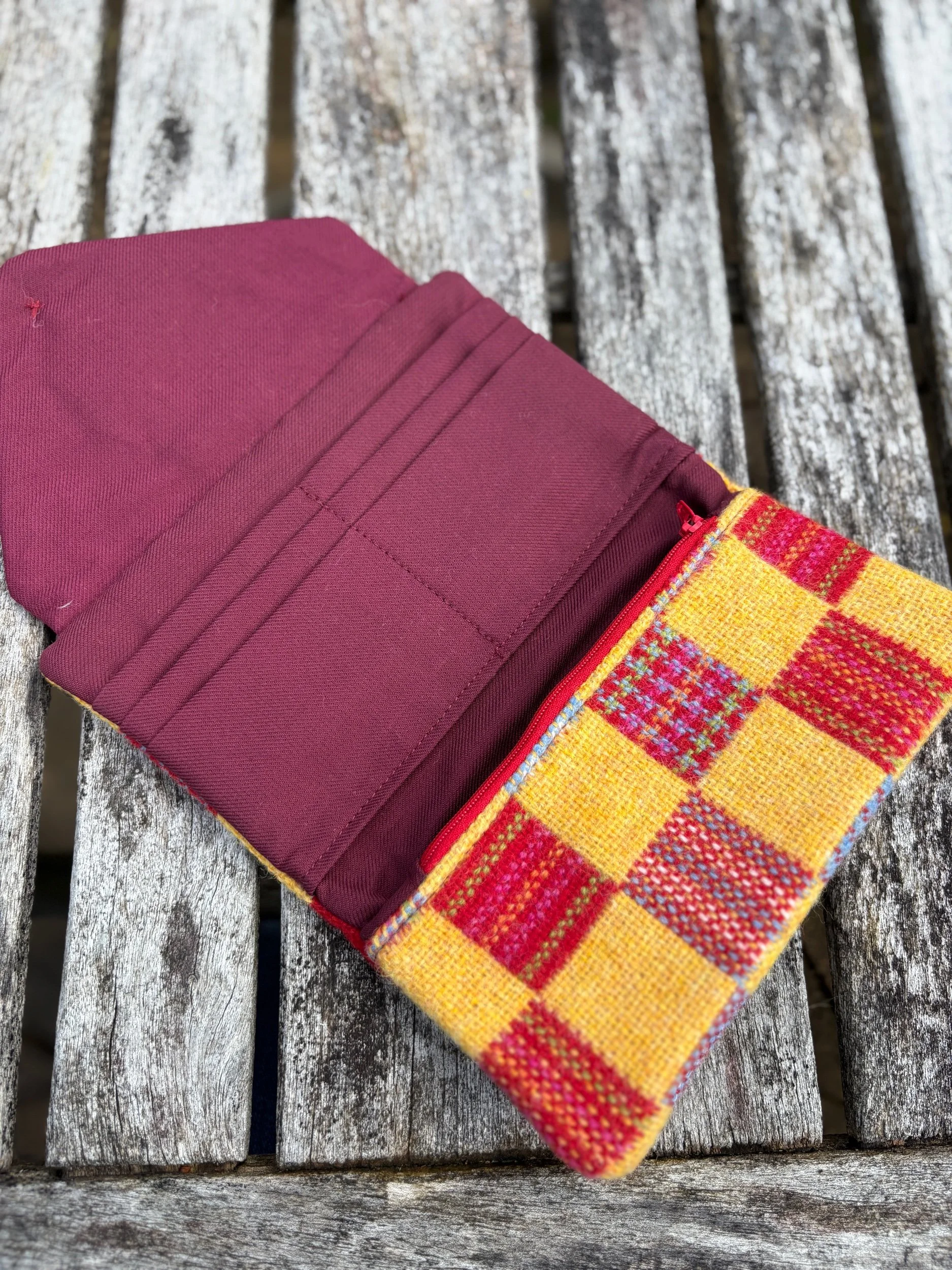 Full interior view of handmade Scottish clutch bag with red Marton Mills lining and organised compartments