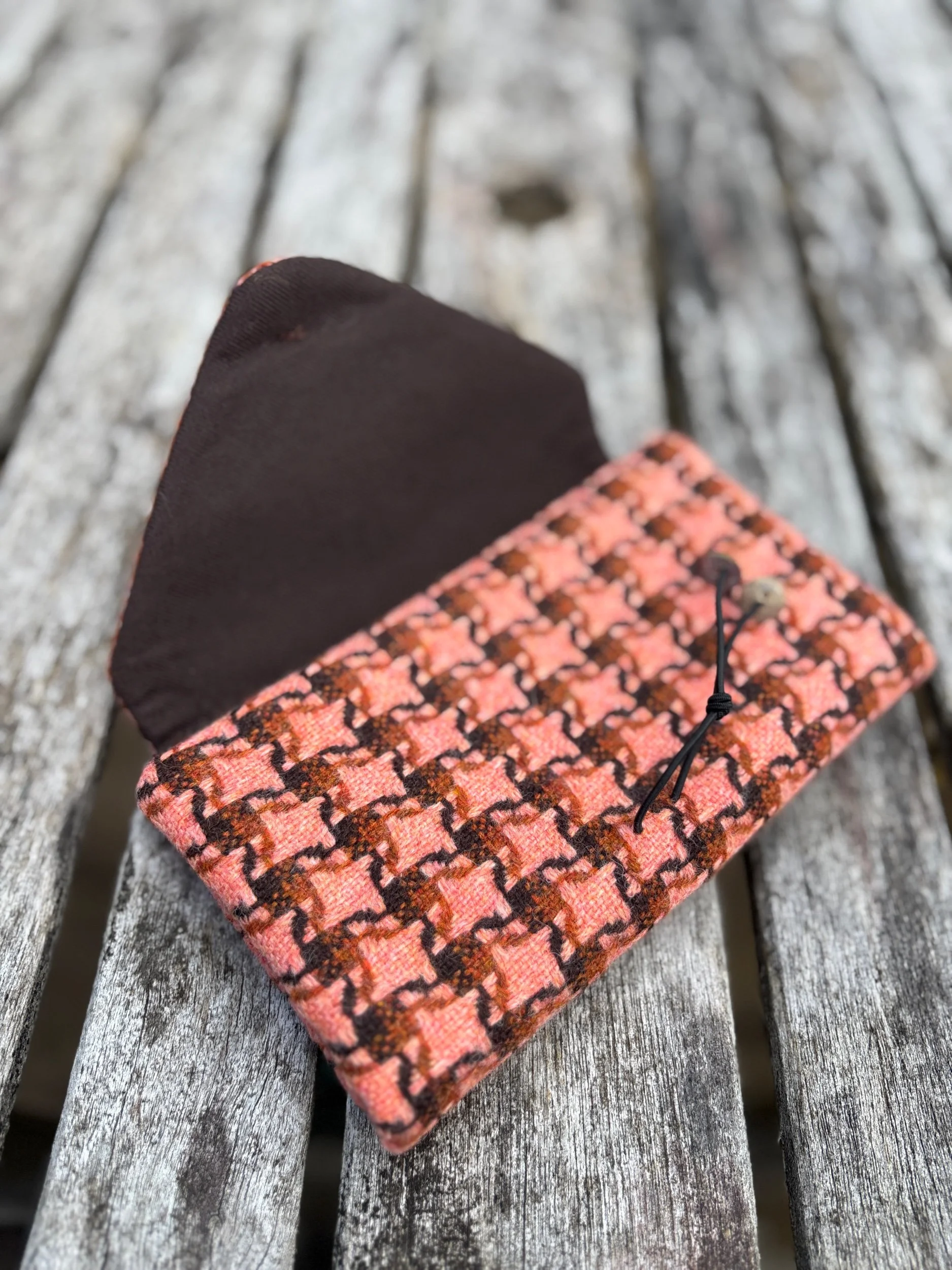 Interior first fold of handmade peach tweed clutch bag, showing craftsmanship and structured design