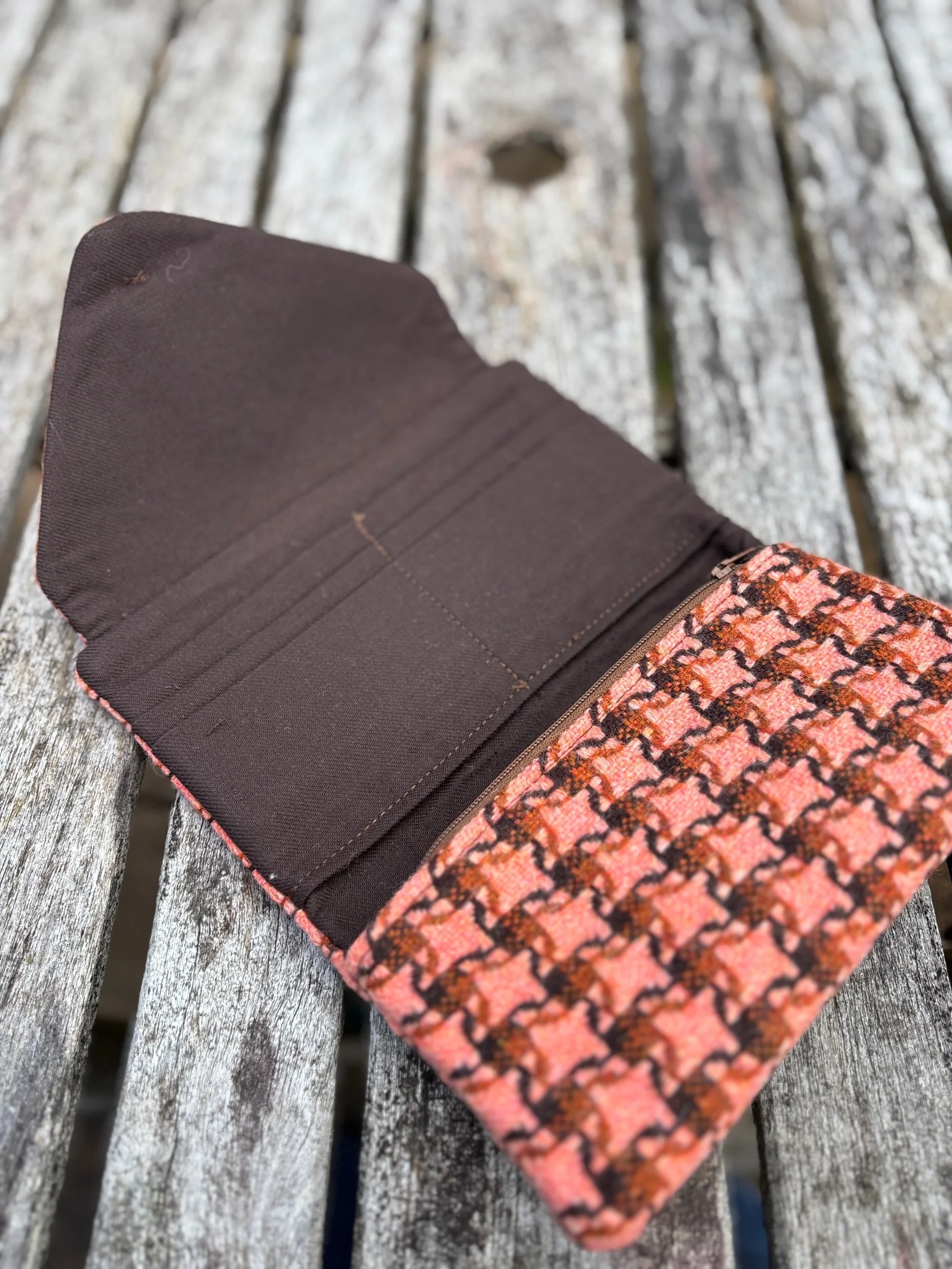 Full interior view of handmade Scottish clutch bag in peach contemporary tweed with organised compartments