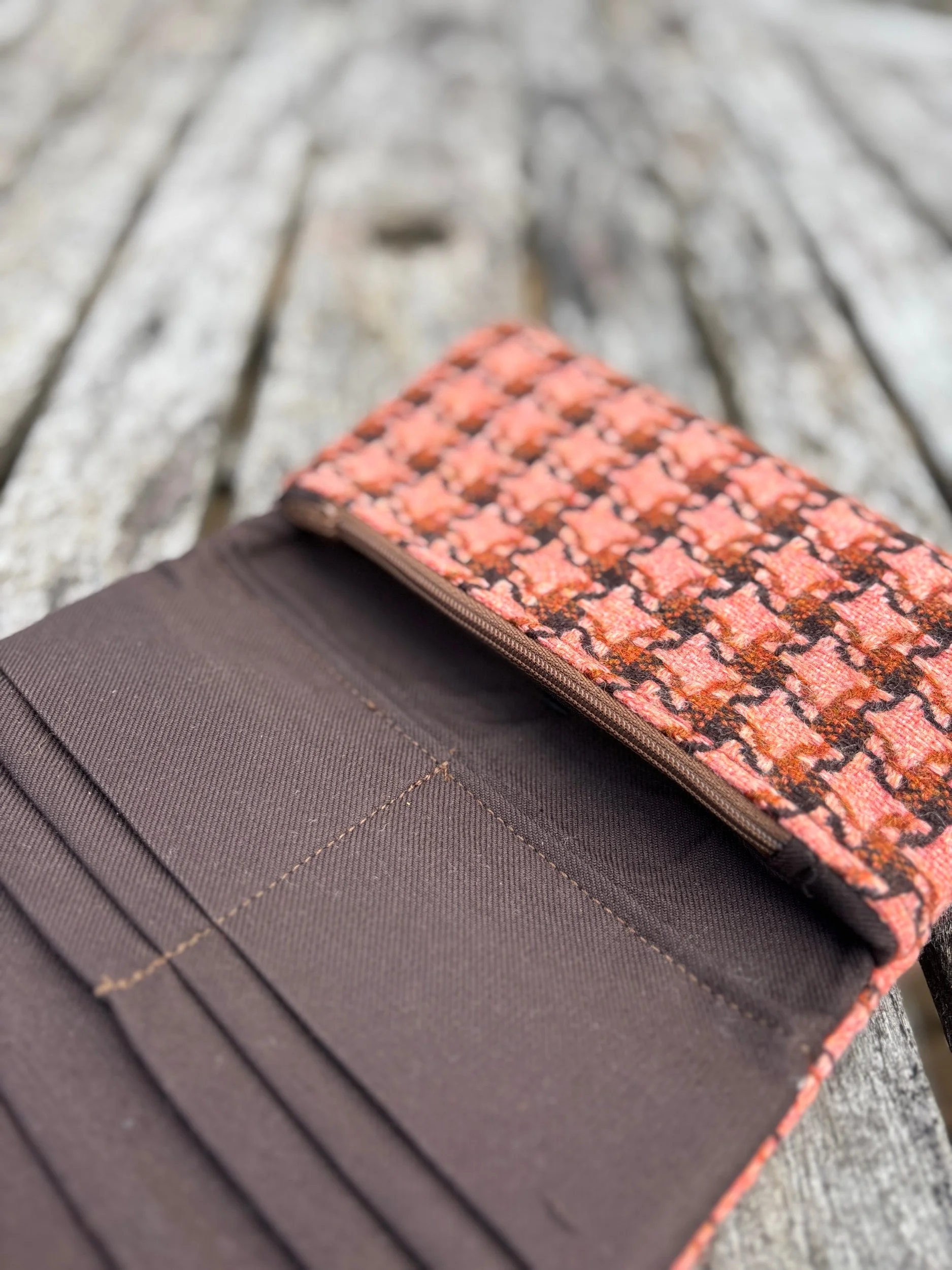 Close‑up of interior zip pocket inside handmade peach contemporary tweed clutch bag by Julia Cunningham