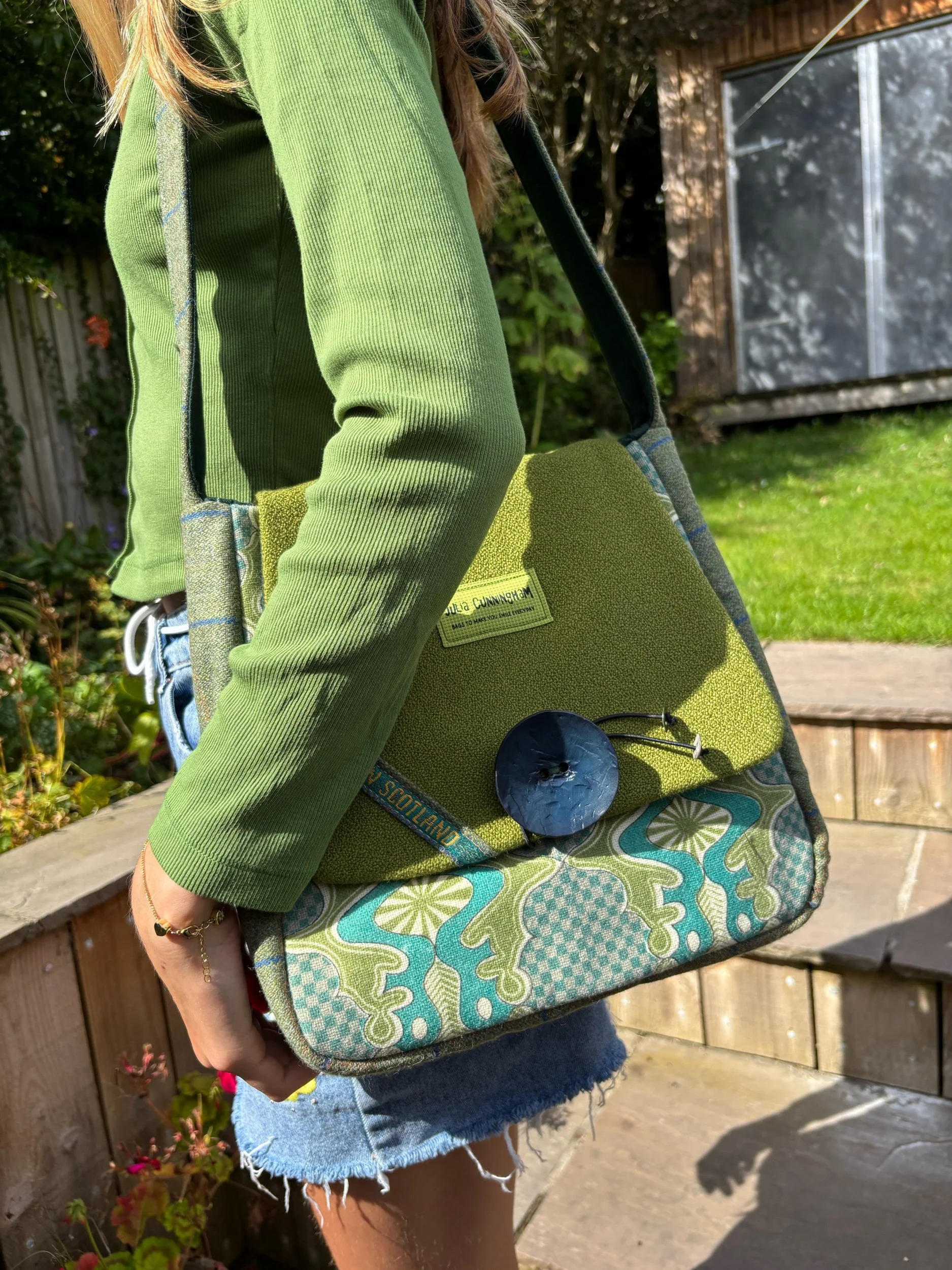 model wearing green tweed vintage shoulder bag by Julia Cunningham