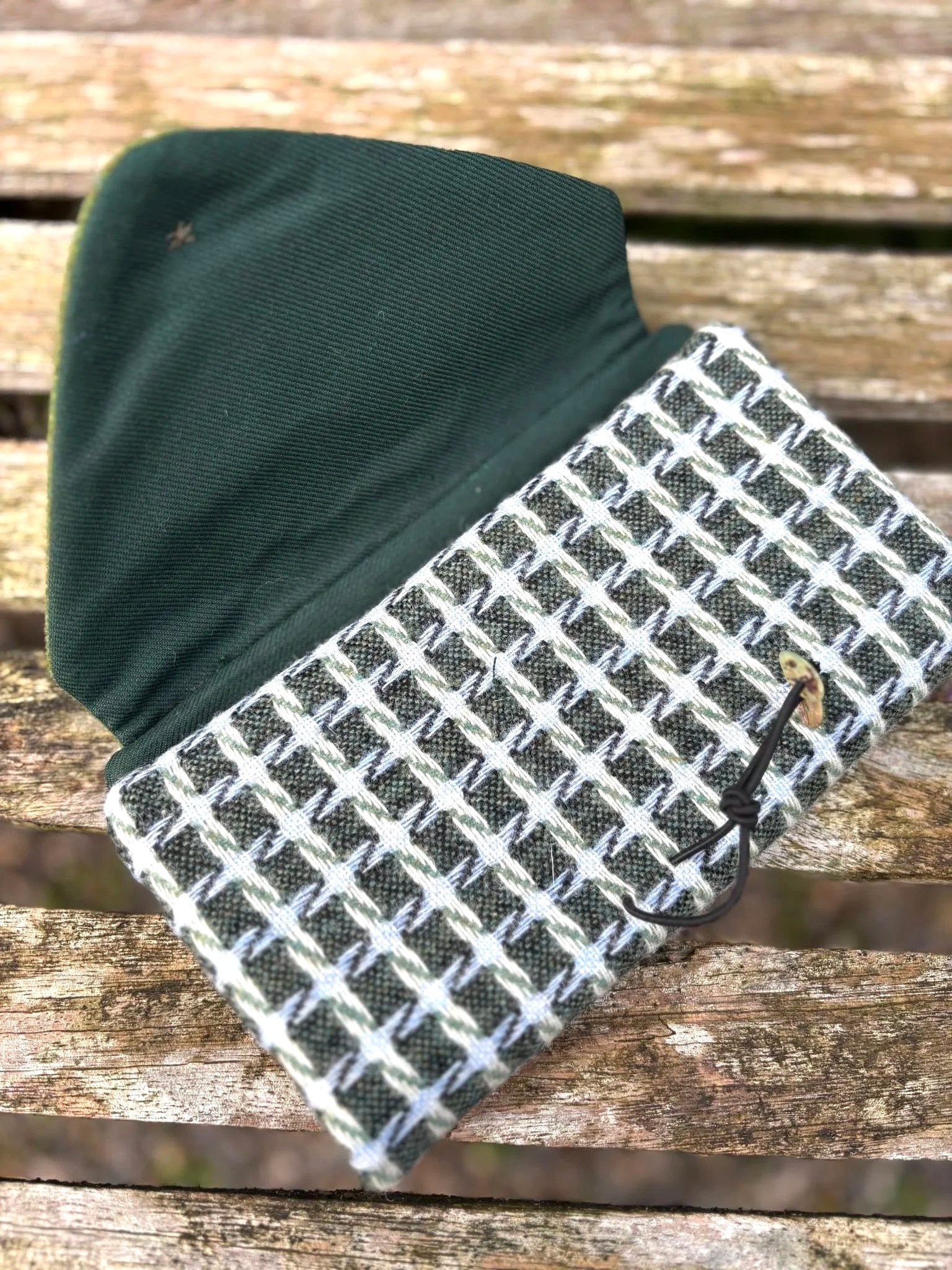 The fabric and shell button detail on handmade green Hinnigan clutch bag made in Scotland