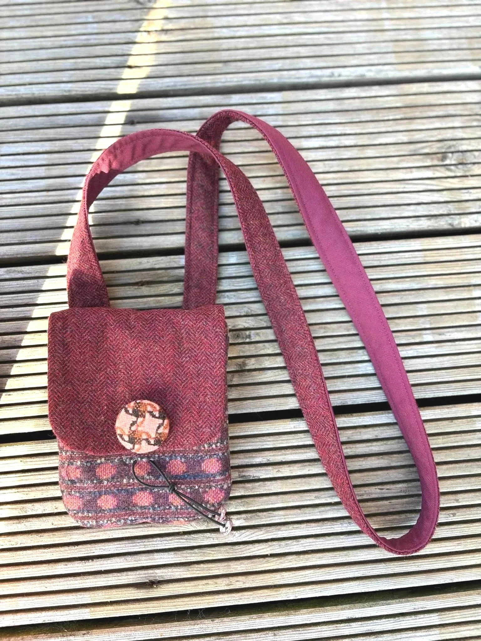 outside image of cross body phone bag in brown and red for true colours