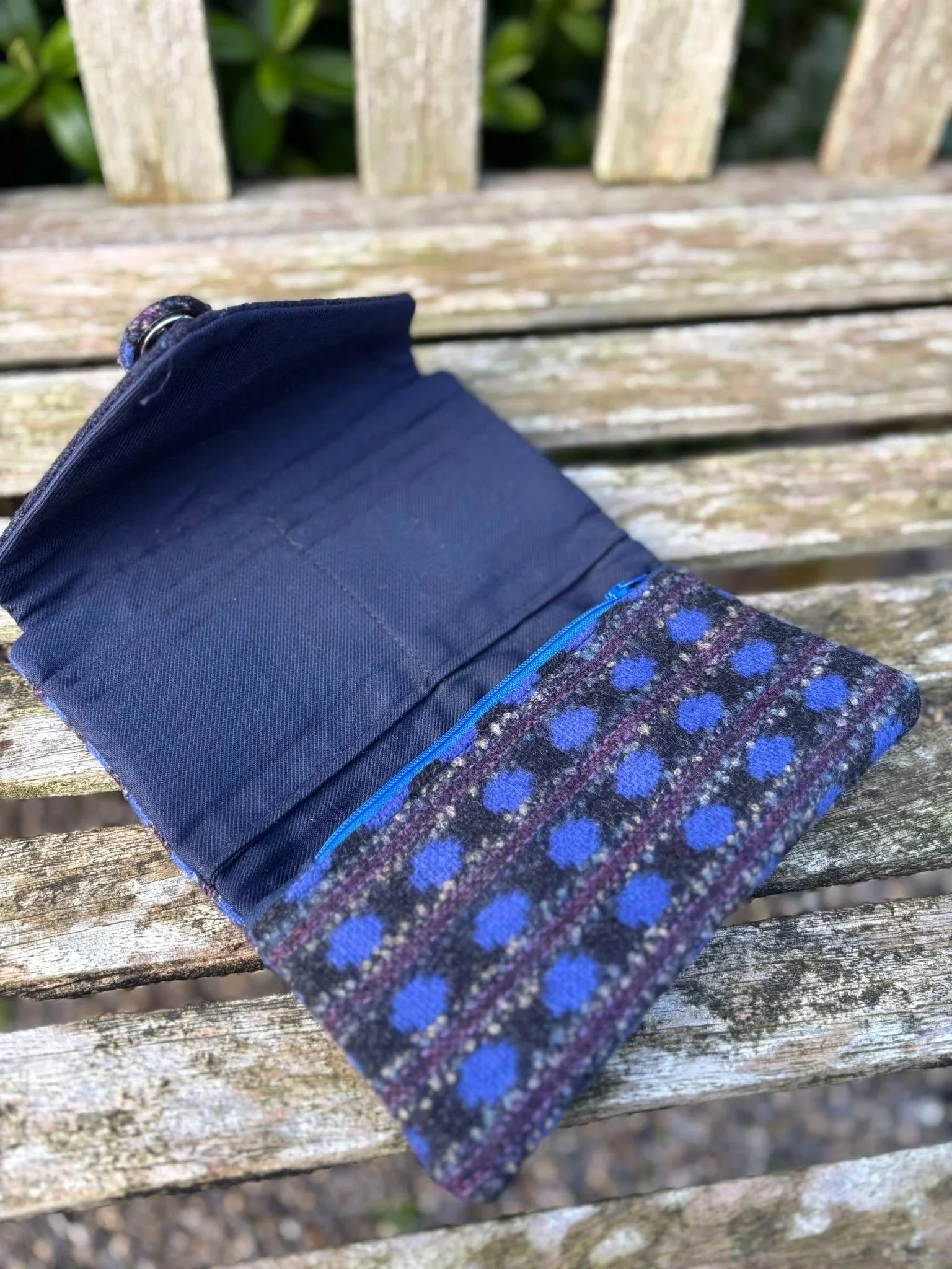 Interior of handmade Scottish clutch purse showing card slots, zip pocket and blue lining by Julia Cunningham
