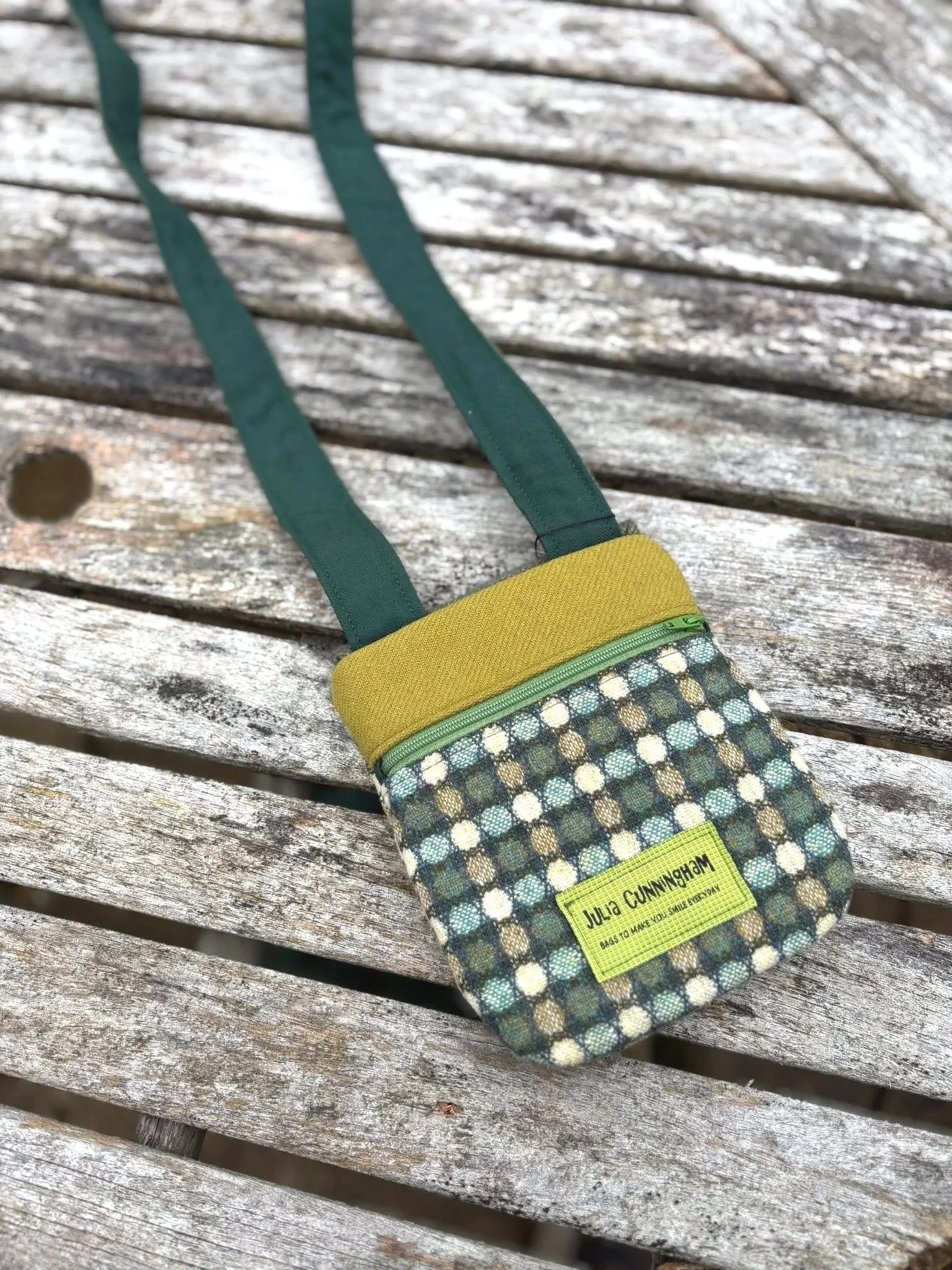 The back details of the zipped pocket crossbody phone bag in tweed handmade Scottish