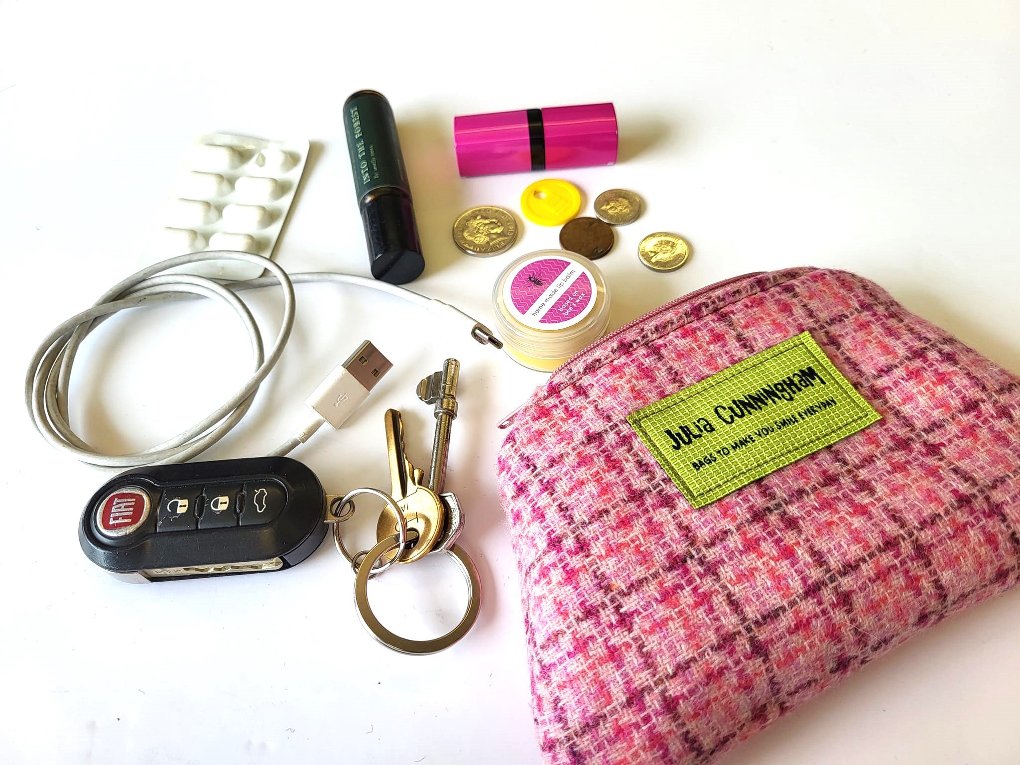 Demonstrating the storage capacity of this pink tweed lavender purse, handcrafted in Scotland.