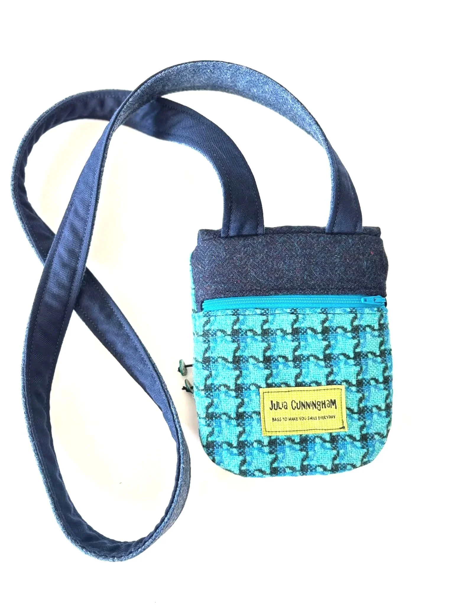 back of a handmade tweed cross body phone bag in blue with zip detail by julia cunningham