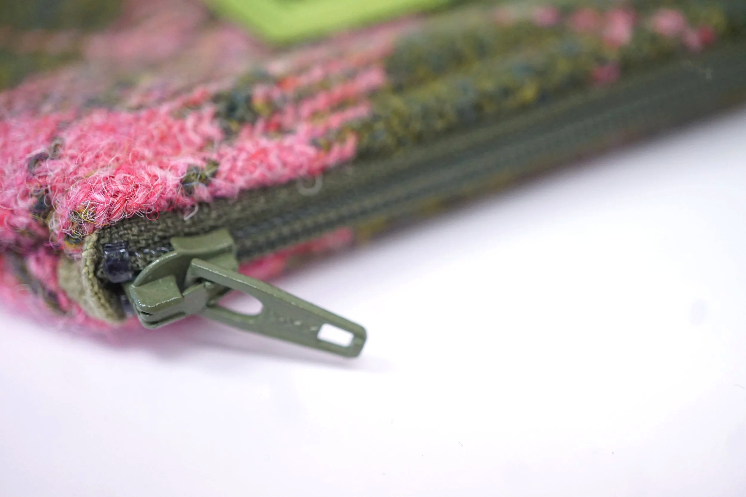 showing zipped detail of Pink and olive Harris Tweed lavender-filled zipped storage purse, handmade in Scotland by Julia Cunningham