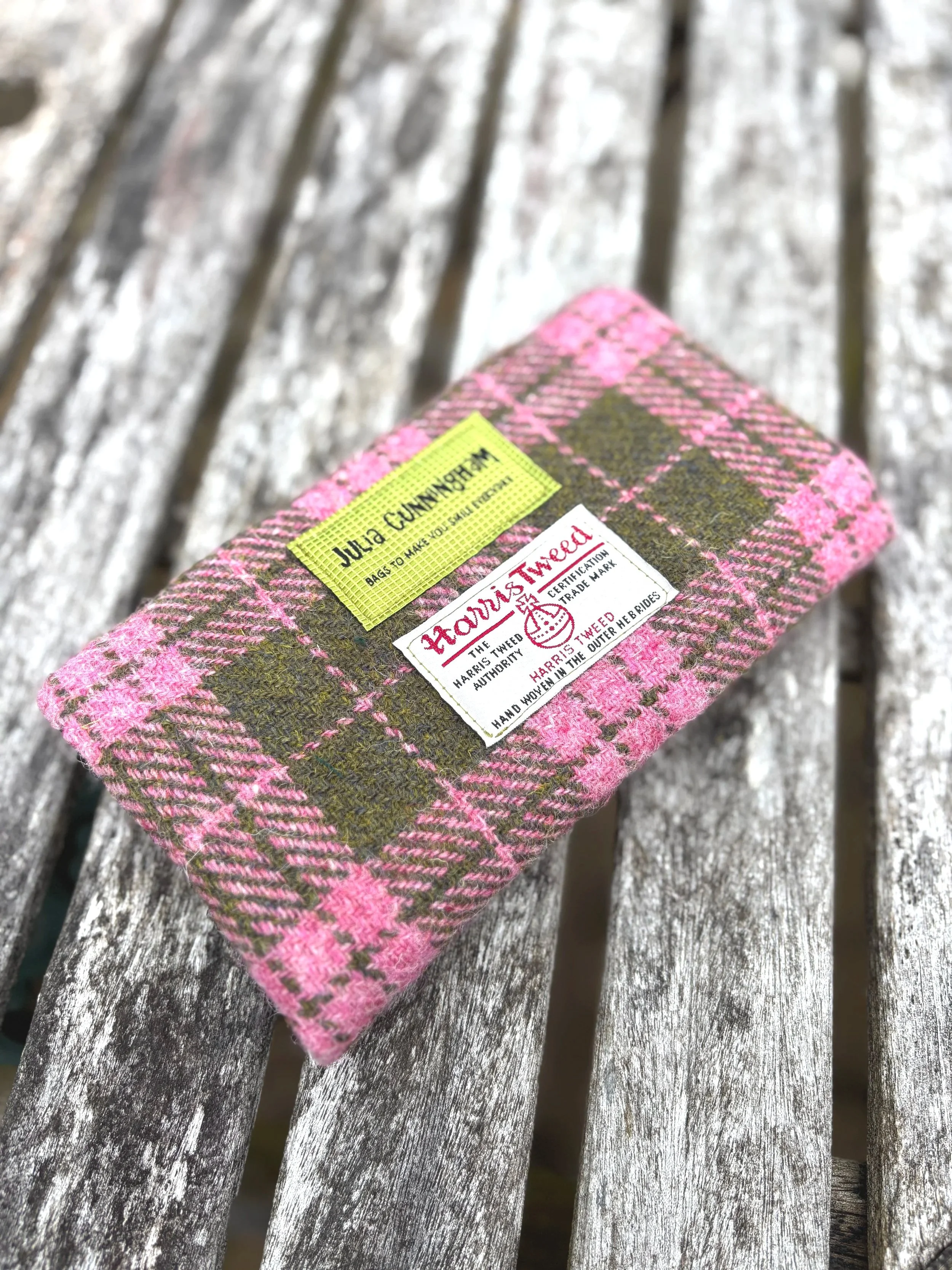 back view of Harris tweed clutch bag in pink and olive showing Julia Cunningham and Harris tweed labels