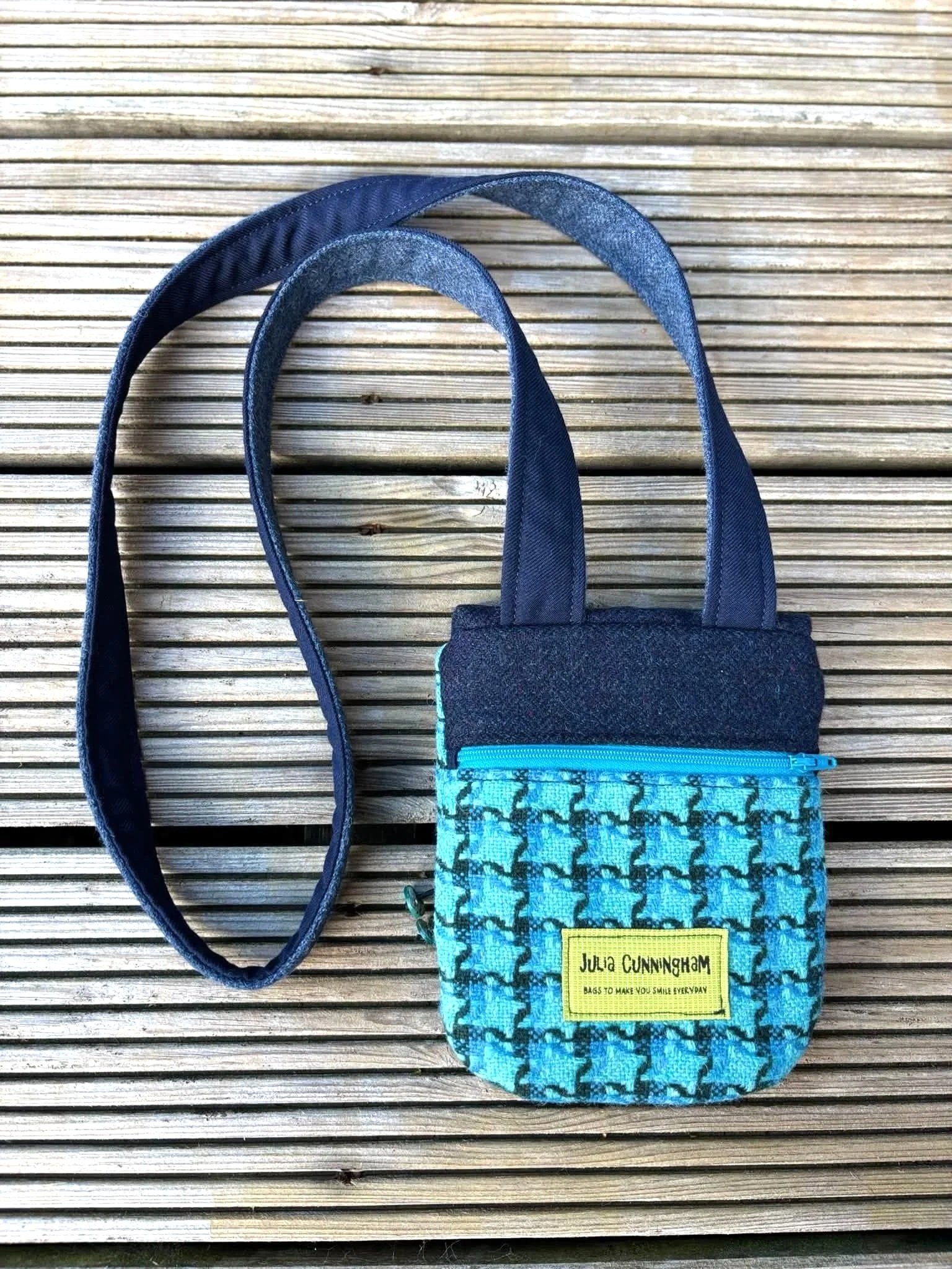 back of a cross body phone bag in blue Hinnigan tweed outside