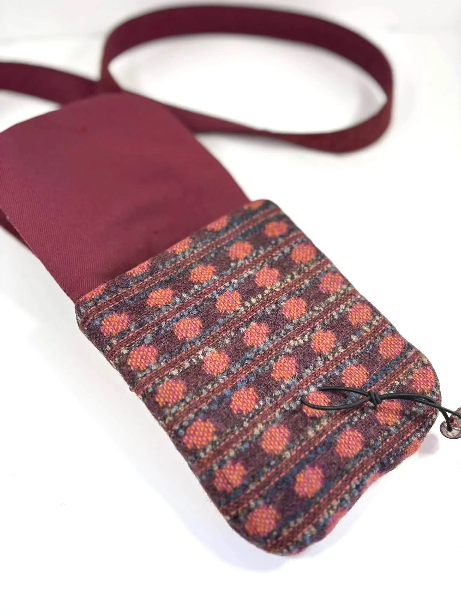 inside a cross body phone bag the tweedling burgundy lining