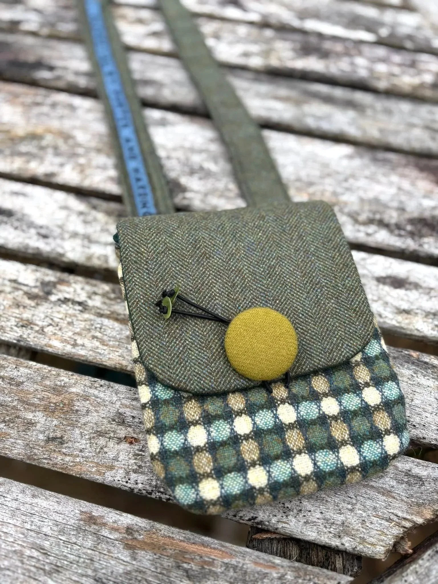 Handmade Hinnigan tweed crossbody phone pouch with green flap, crafted in Scotland by Julia Cunningham