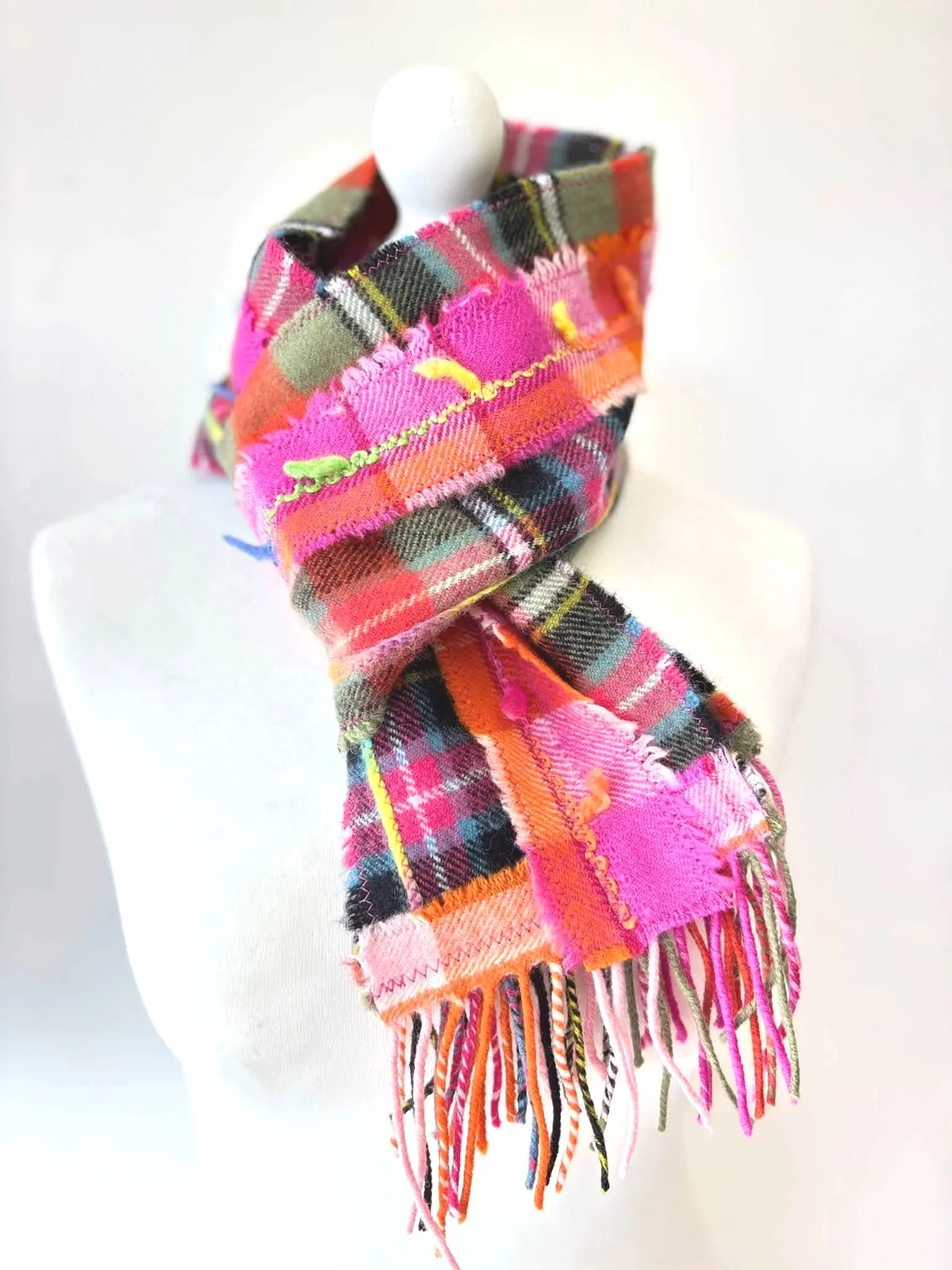 Julia Cunningham pink and green wool scarf on a mannequin