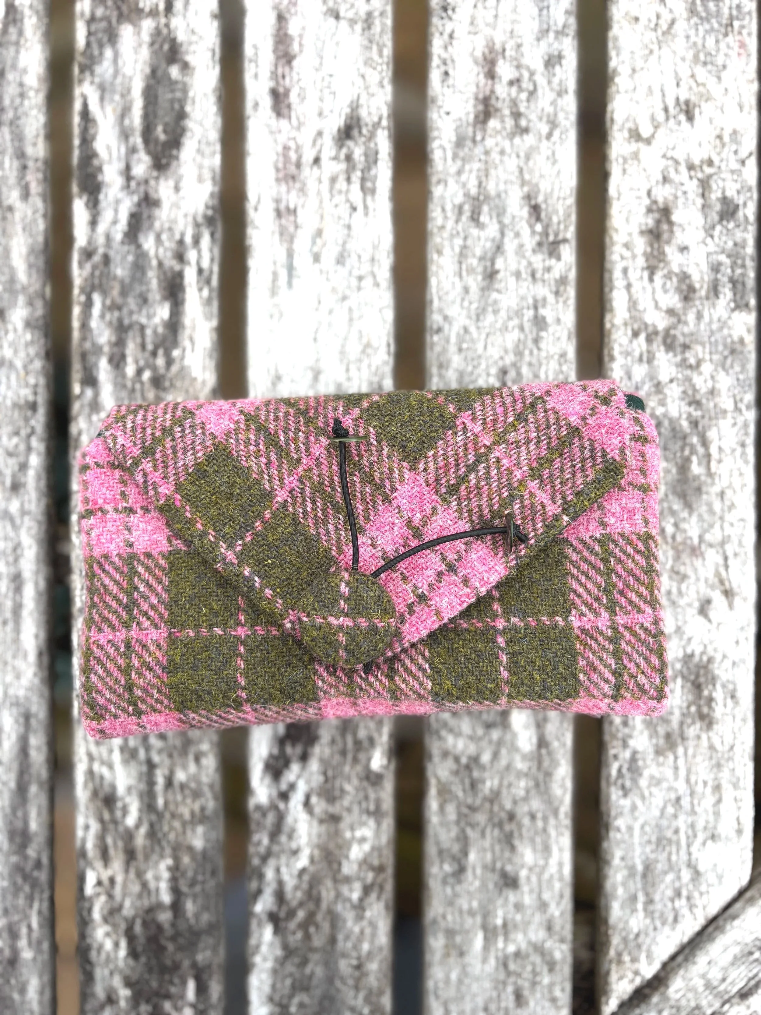 front view of Harris Tweed clutch bag in pink and olive