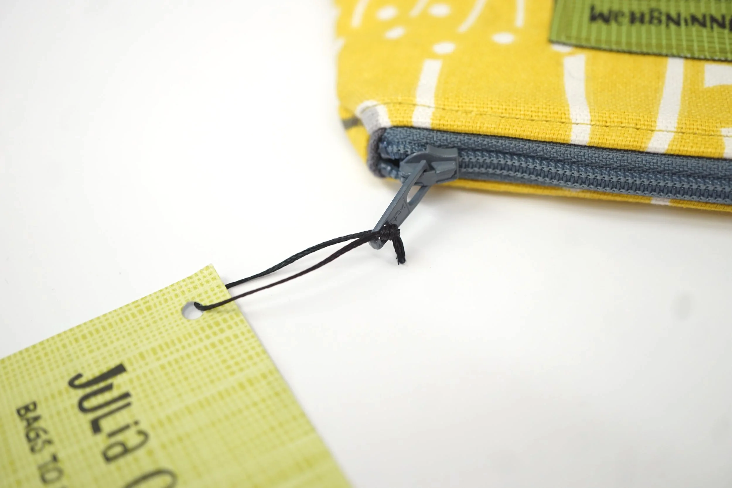 Close-up of floral mustard yellow purse and zip details