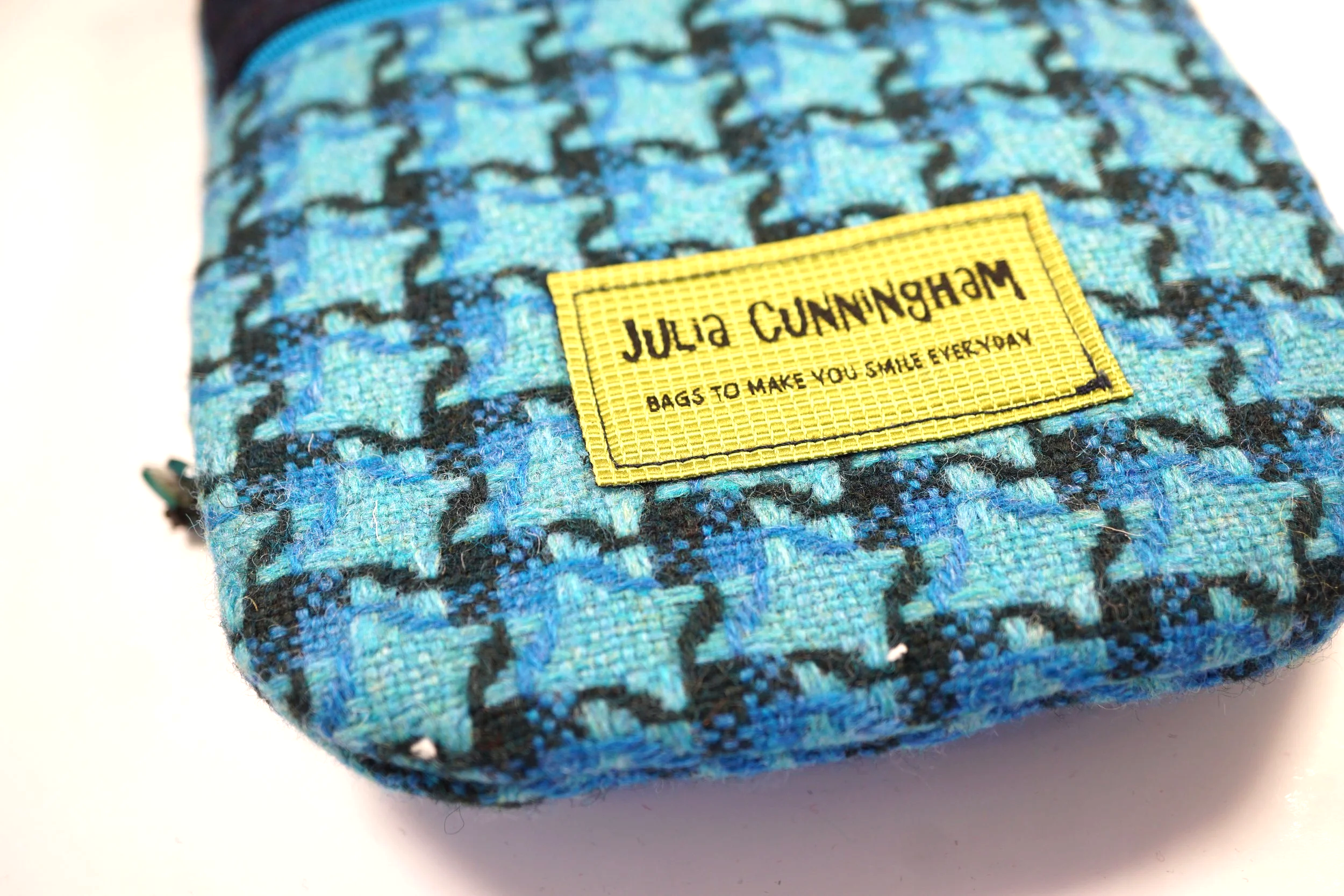 Julia Cunningham label on a crossbody phone bag in blue Hinnigan Tweed tweed