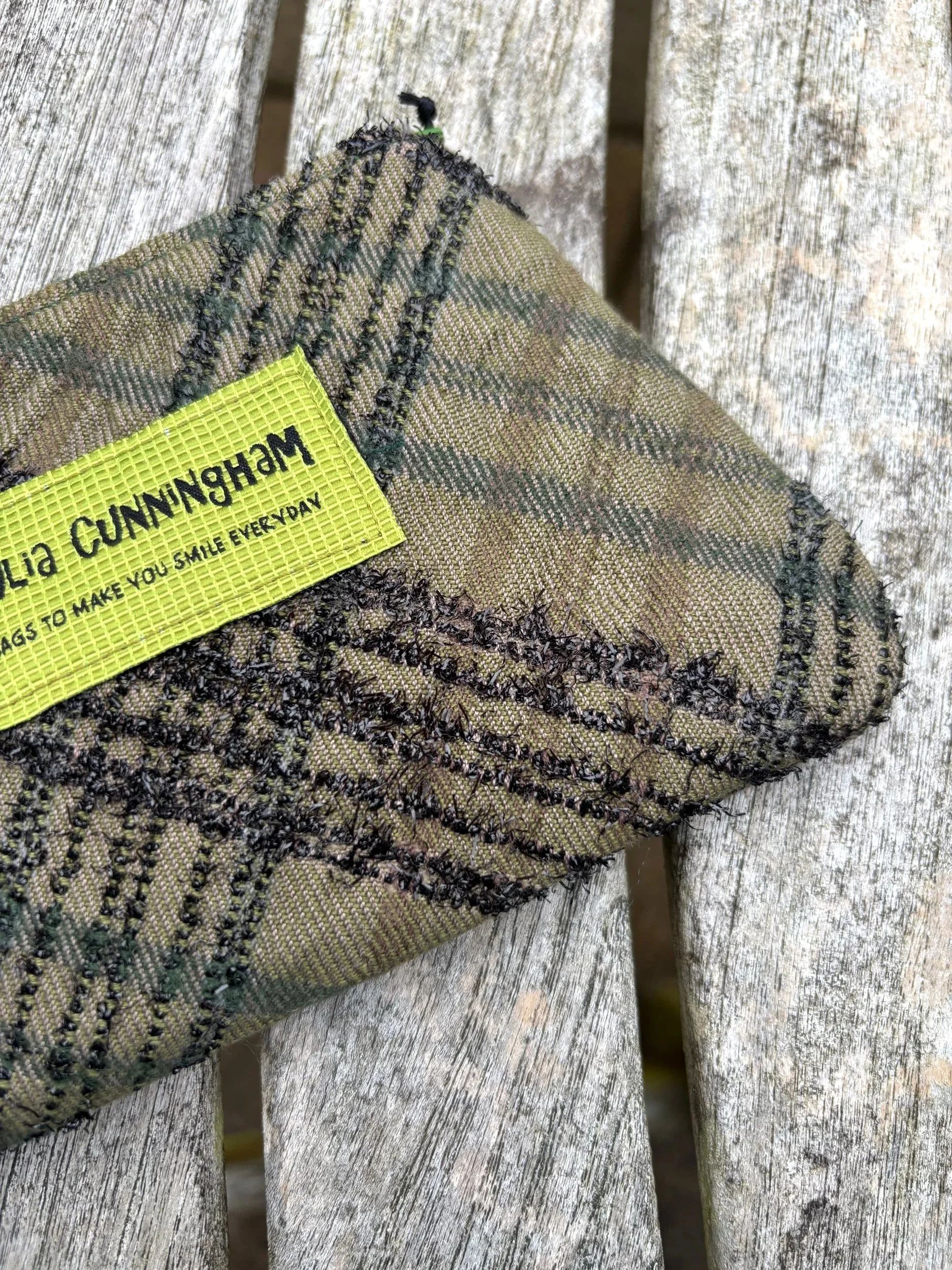 Close‑up detail of the green vintage Lochcarron tweed fabric used in the handmade Scottish lavender purse.