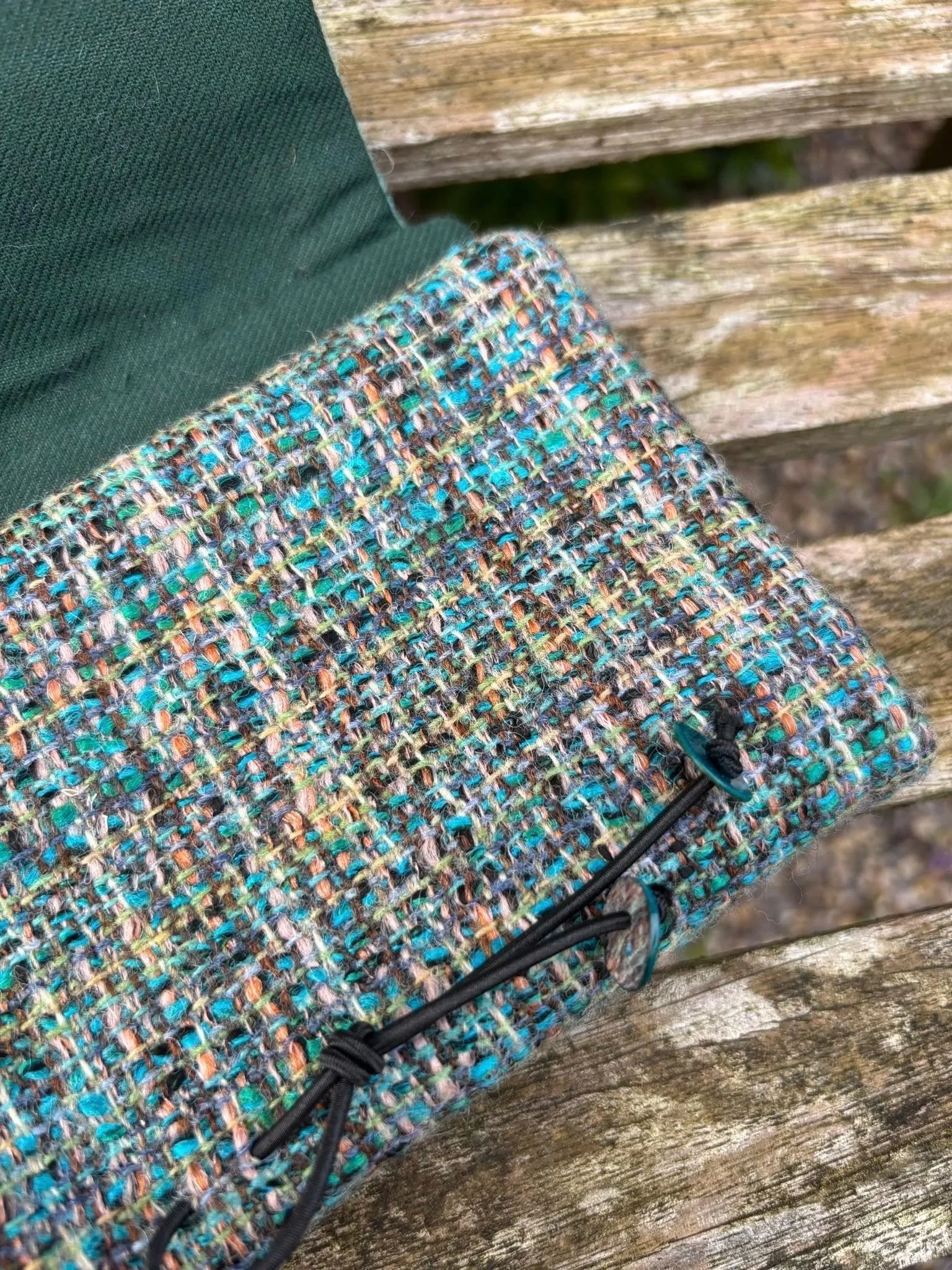 Fabric and  shell button detail on handmade blue green clutch bag made in Scotland
