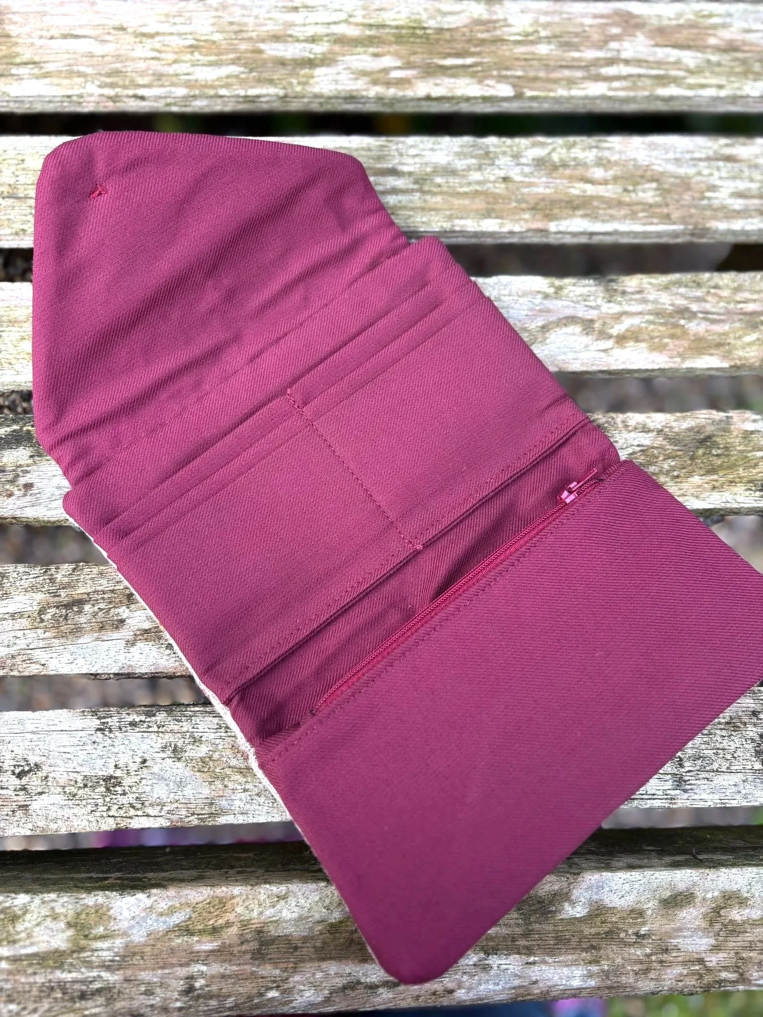 Interior of handmade Scottish clutch purse showing card slots, zip coin pocket and red lining by Julia Cunningham