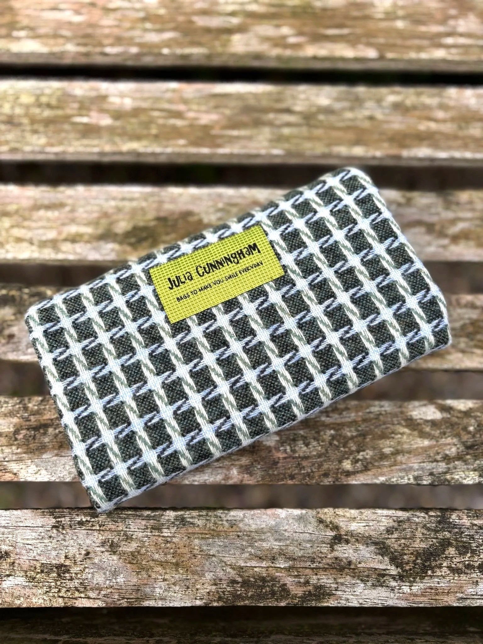 Back and brand label of handmade green clutch bag made in Scotland