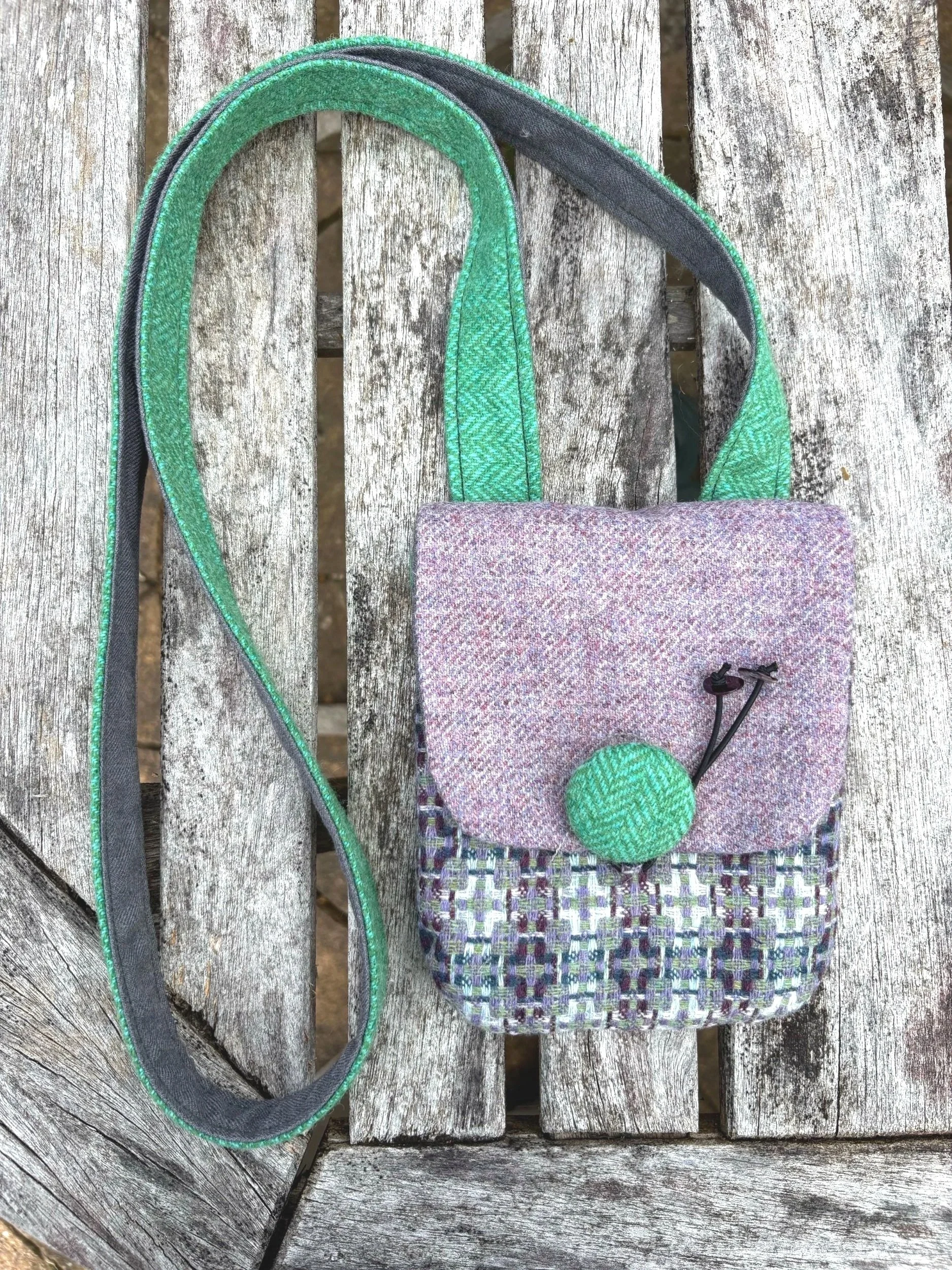 Front of tweedling crossbody phone bag in purple