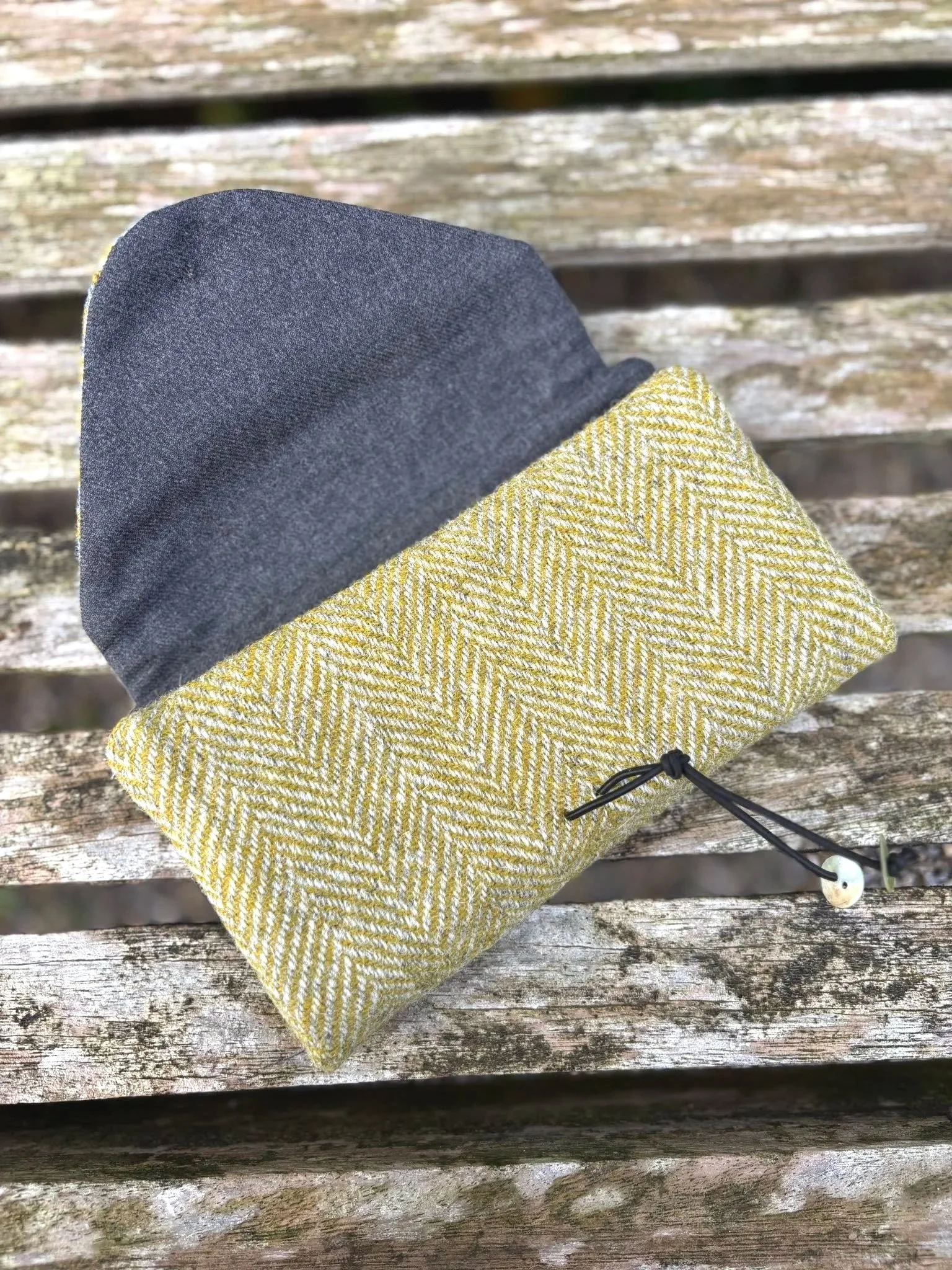 Fabric Texture, colour and shell button detail on handmade Harris Tweed clutch bag made in Scotland