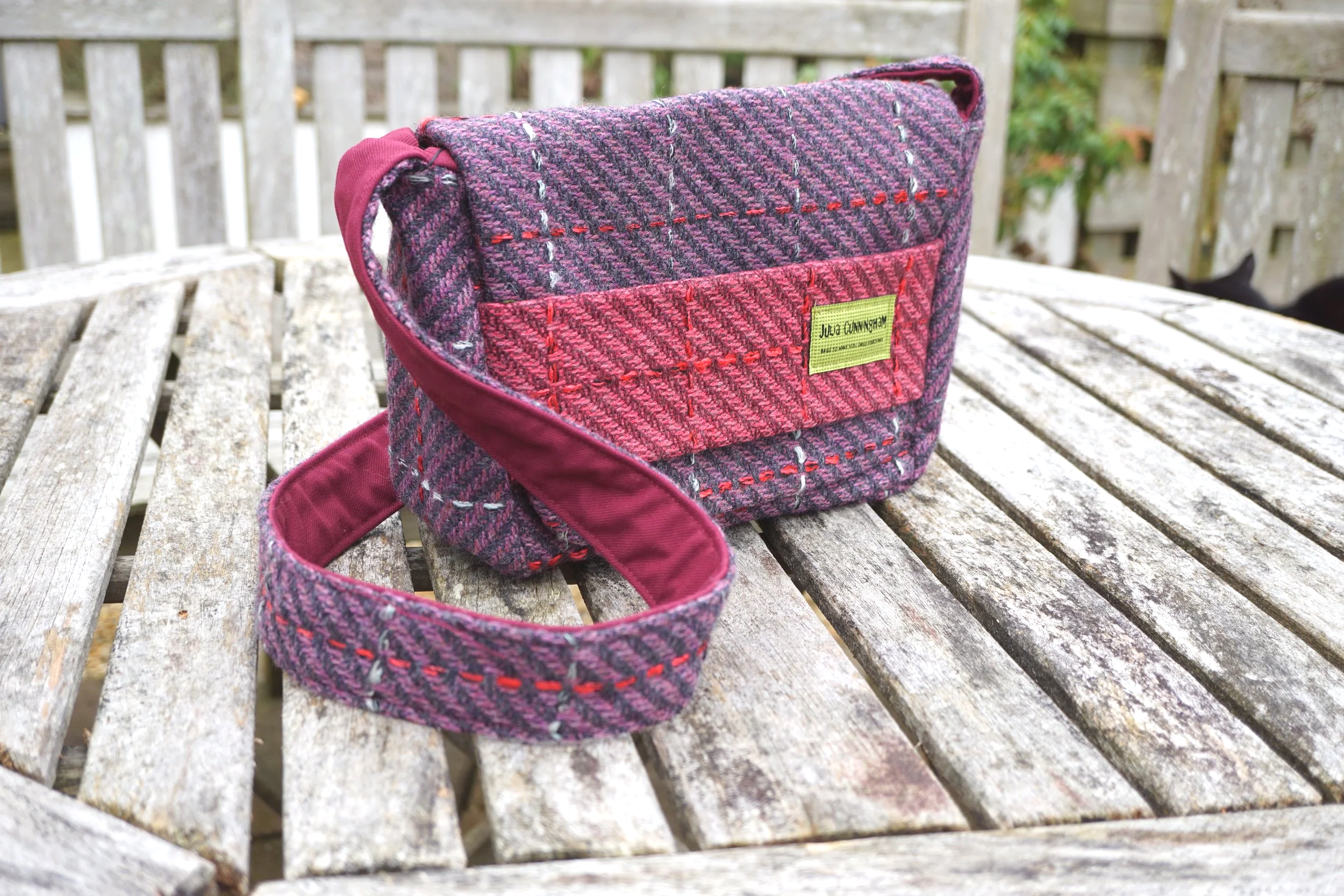 Handmade pink Hinnigan wool tweed crossbody bag with fabric strap closure, made in Scotland by Julia Cunningham