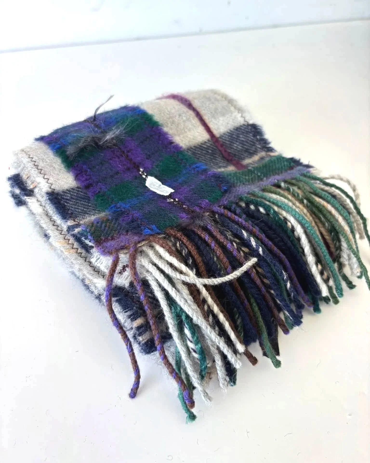 close up of handmade wool scarf in grey and purple