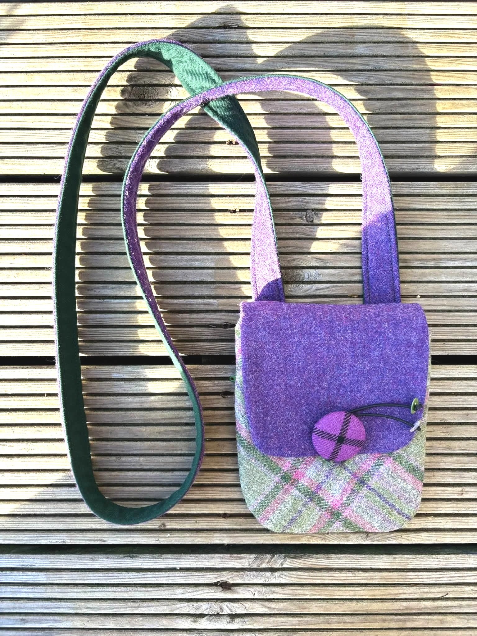 outside image of the handmade crossbody phone bag in purple and green by Julia Cunningham