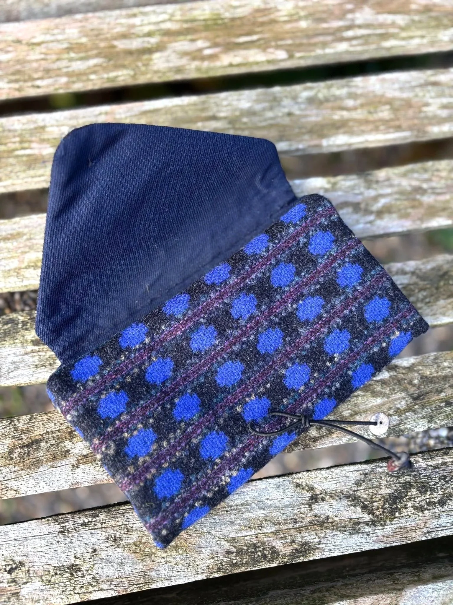 Fabric and shell button detail on handmade blue tweed clutch bag made in Scotland