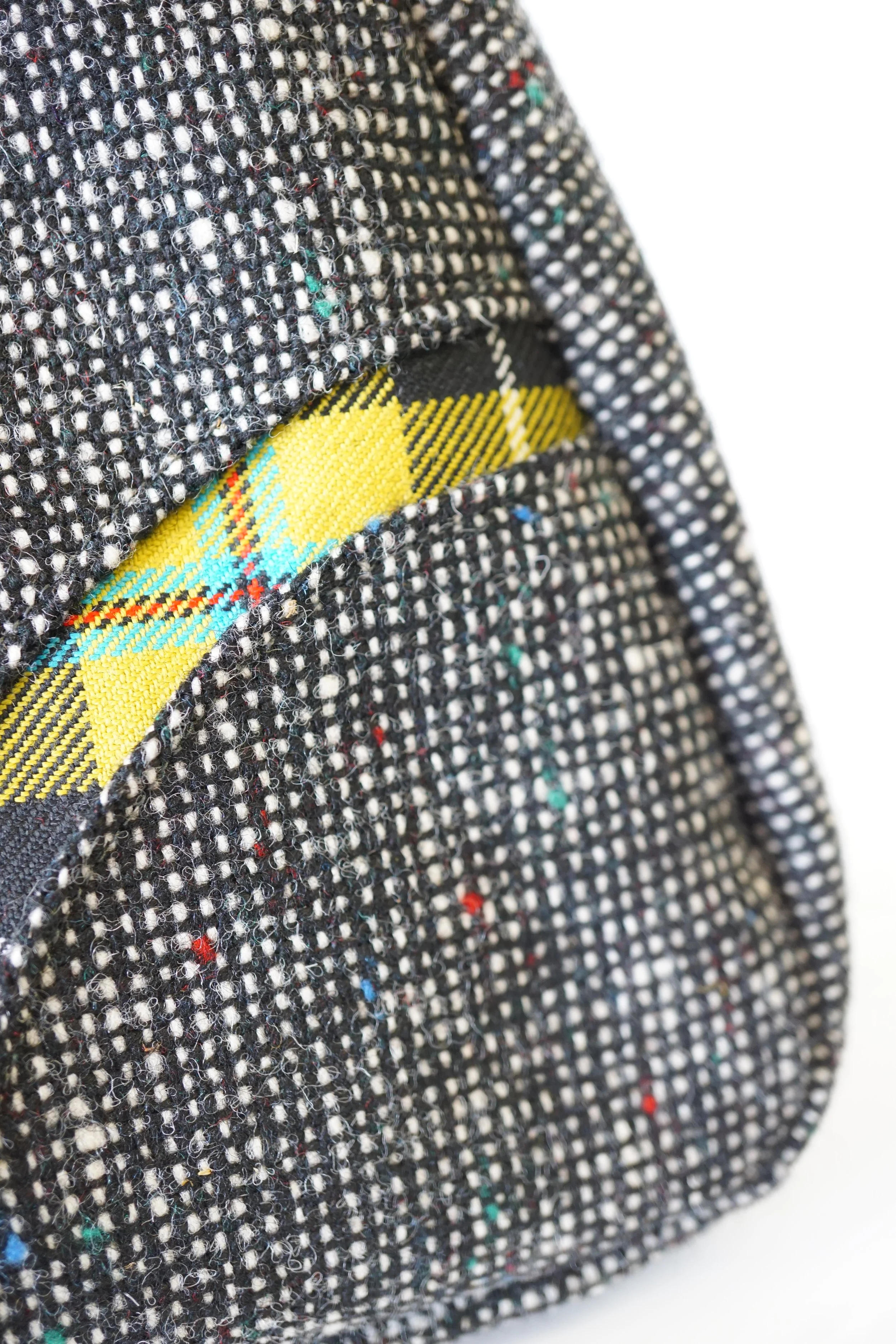 Close‑up of Cornish tartan Panel of  hand‑carried handles on the black Scottish tweed Fantoosh handbag.