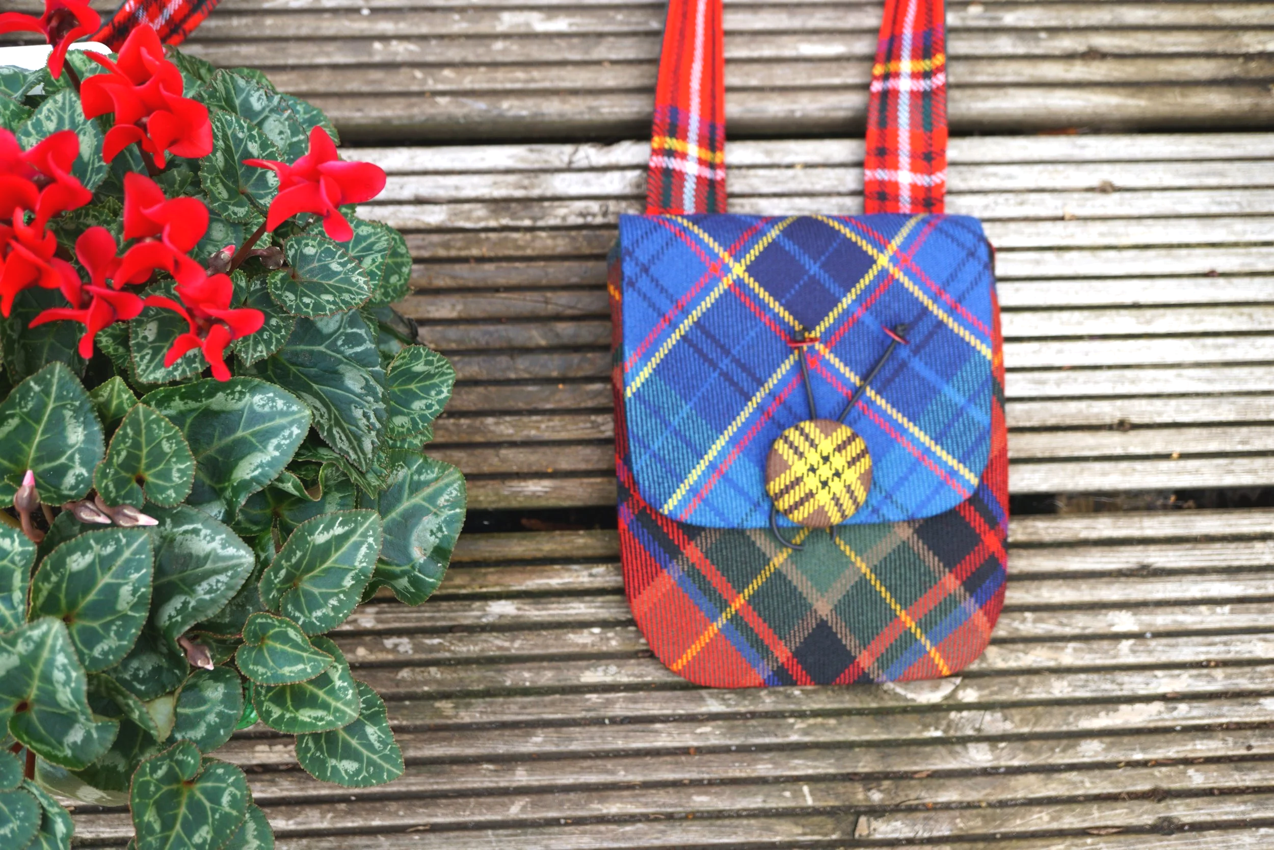 Front view of the Mixed Tartan Tweedling with yellow tartan button