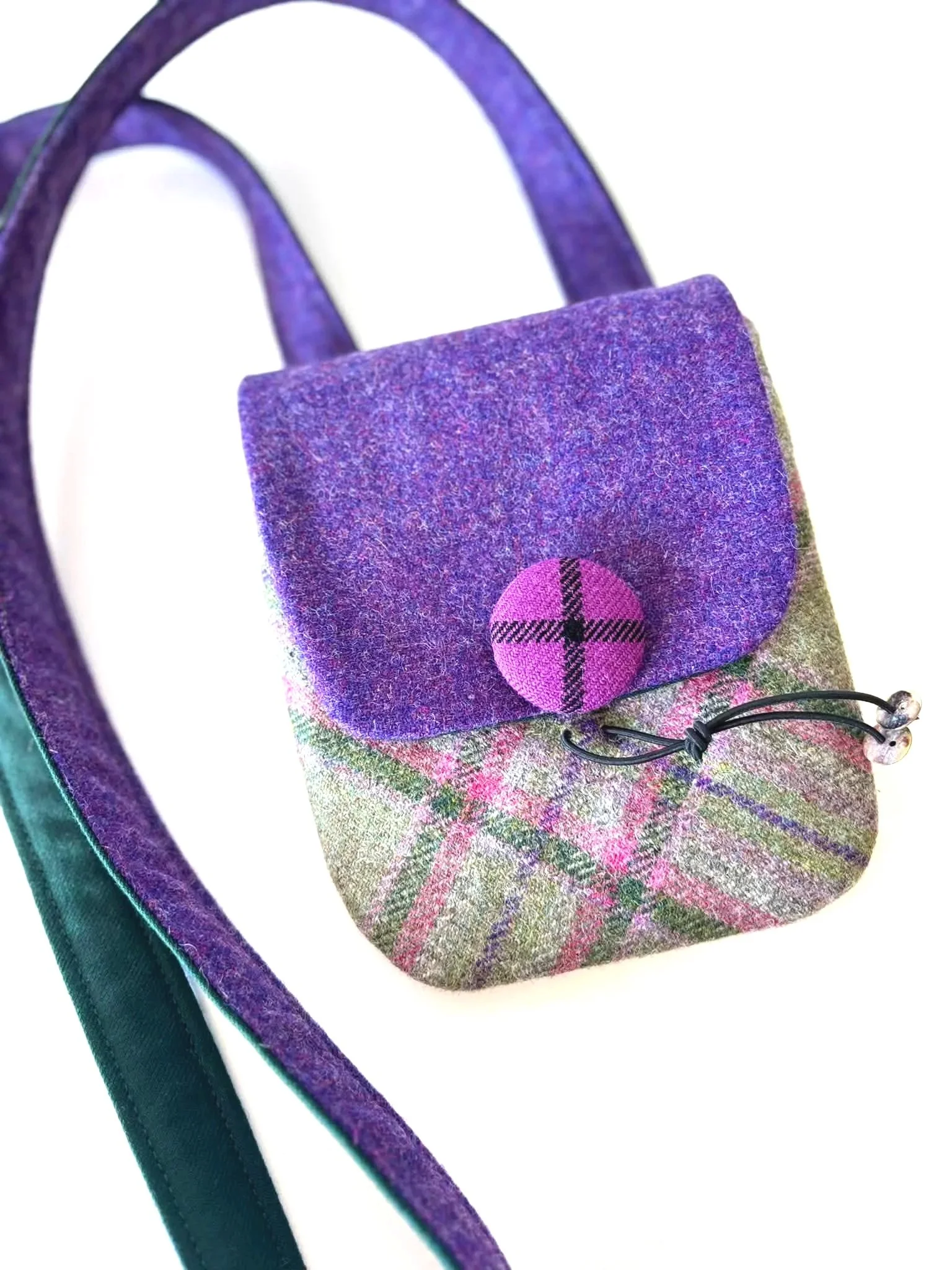 front of the handmade cross body phone bag in green purple and pink