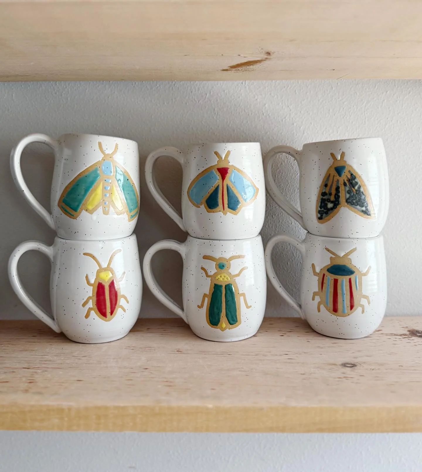 Bug Mugs! Some colorful test pieces for a batch of bug mugs I&rsquo;ll be bringing to Art Fair on the Square this summer. These love bugs are in the shop now 🐞 🪲 🐝 Which is your favorite?? #bugmug #shopsmall