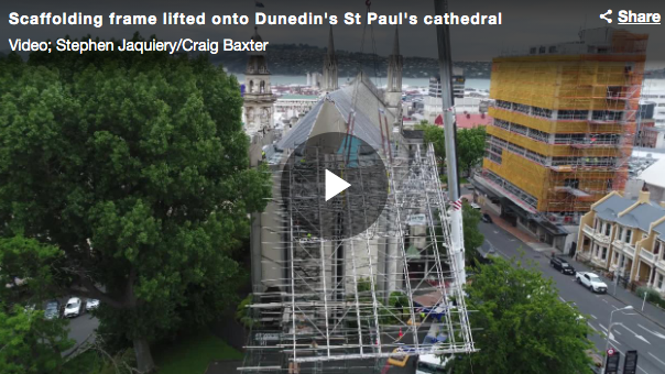 Scaffolding hoisted over cathedral