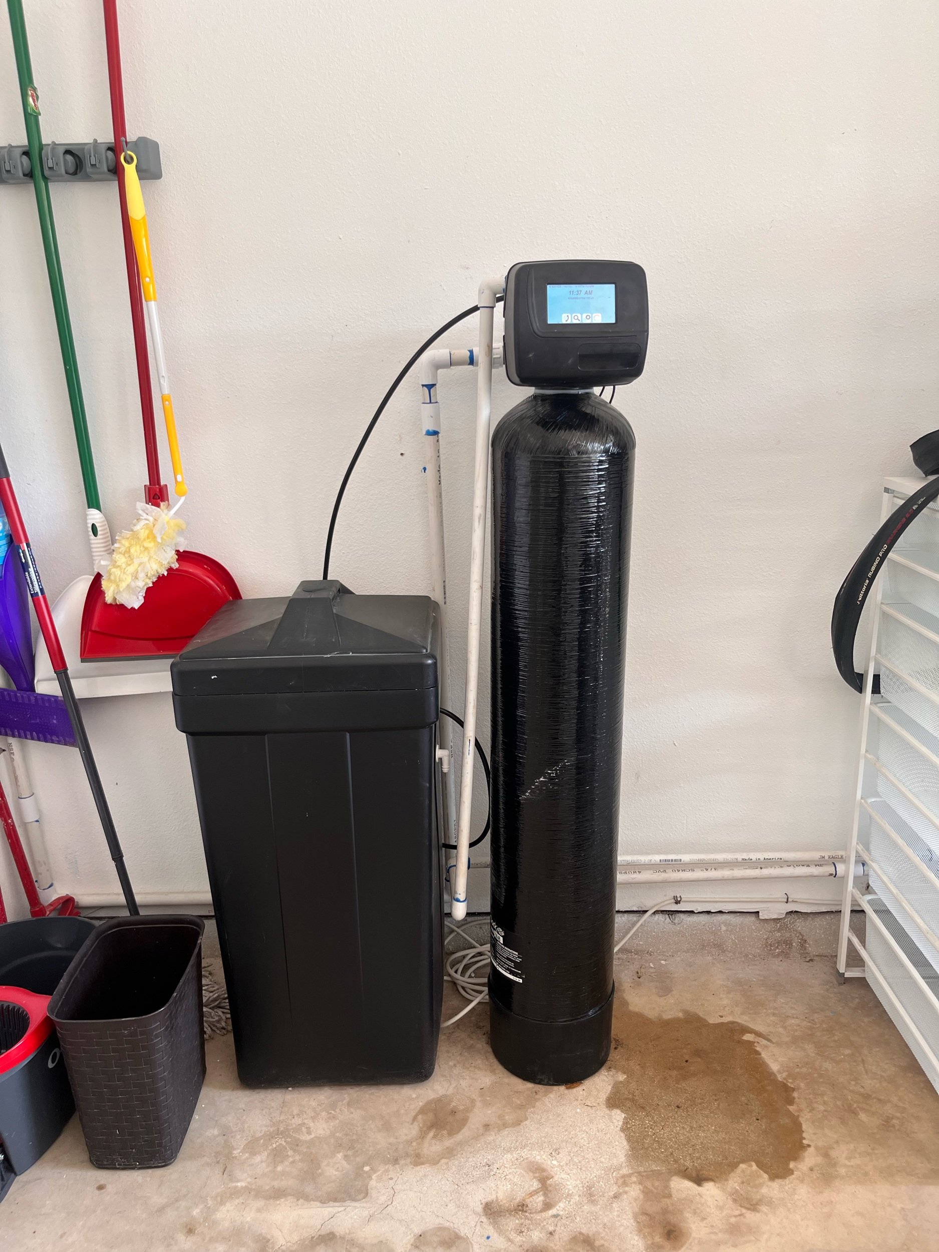 Installed Novaline water softener and brine tank in a San Antonio utility area