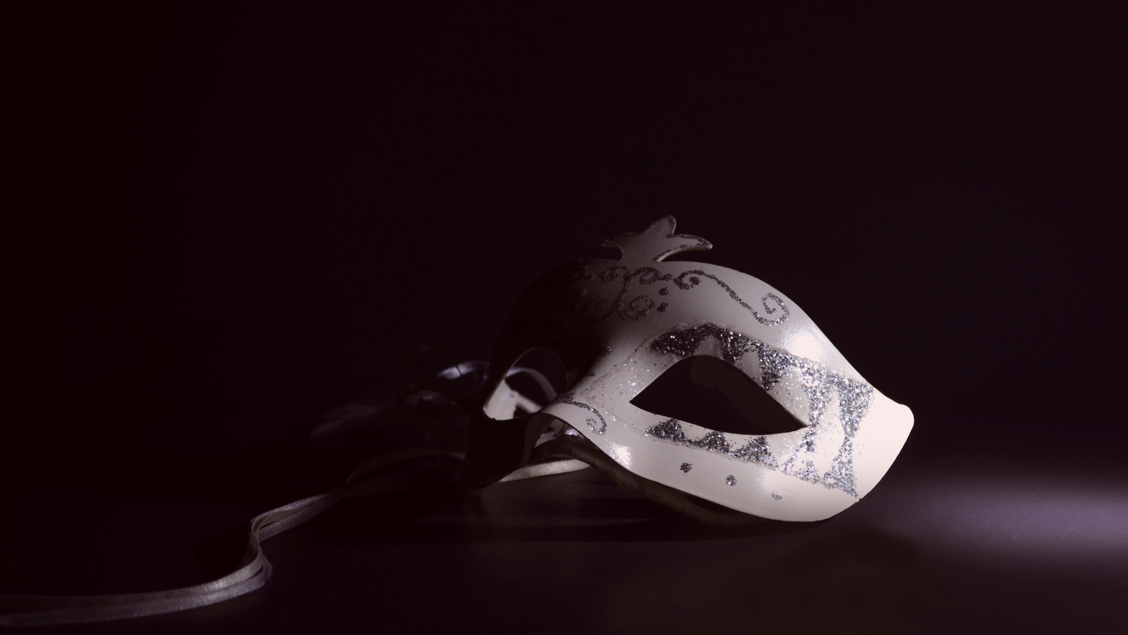 A white cricus mask on a black background with an an overlay text that says Best Selling Author of Erotic Fiction
