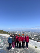 TODCO residents taking a picture with a staff member at Twins Peak overlooking the city of San Francisco.