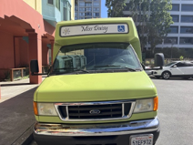 A picture of Miss Daisy, TODCO's transportation shuttle, from the front of the bus outside of Mendelsohn House and next to Alice Street Gardens.