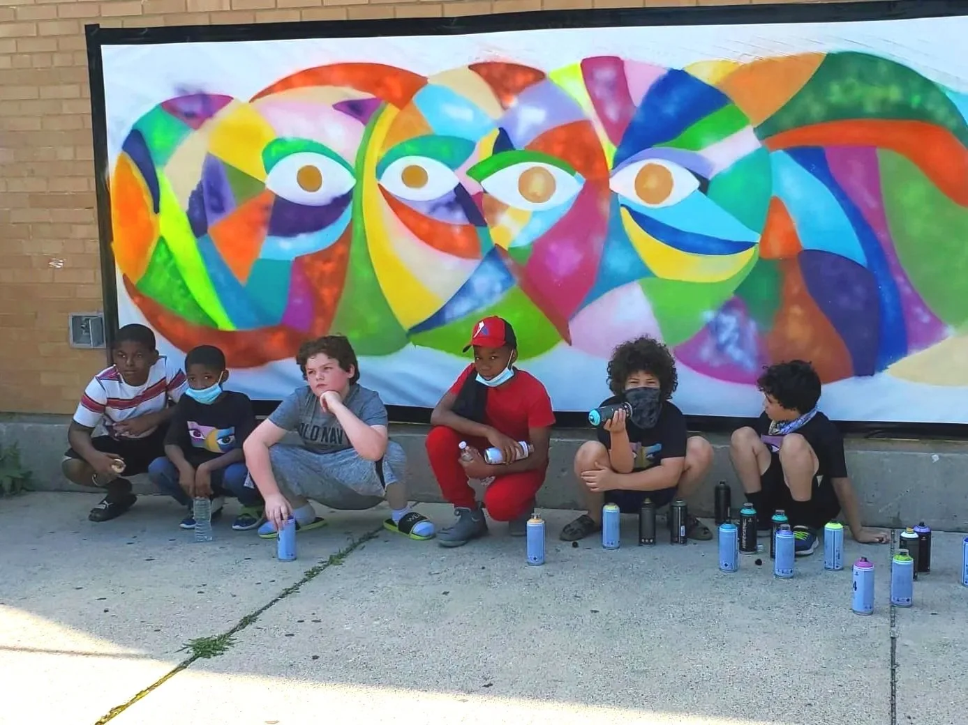 Smiling Eyes mural with kids.jpg