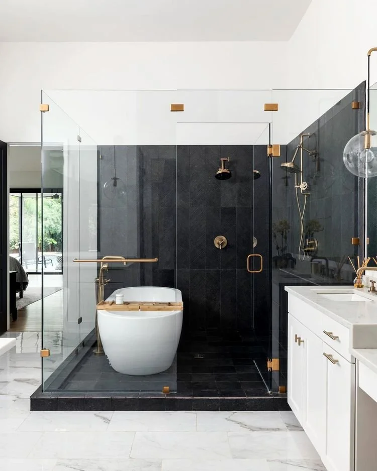Sophisticated Tub-in-Shower Design with Dark Tile and Gold Accents by @harperdesignprojects