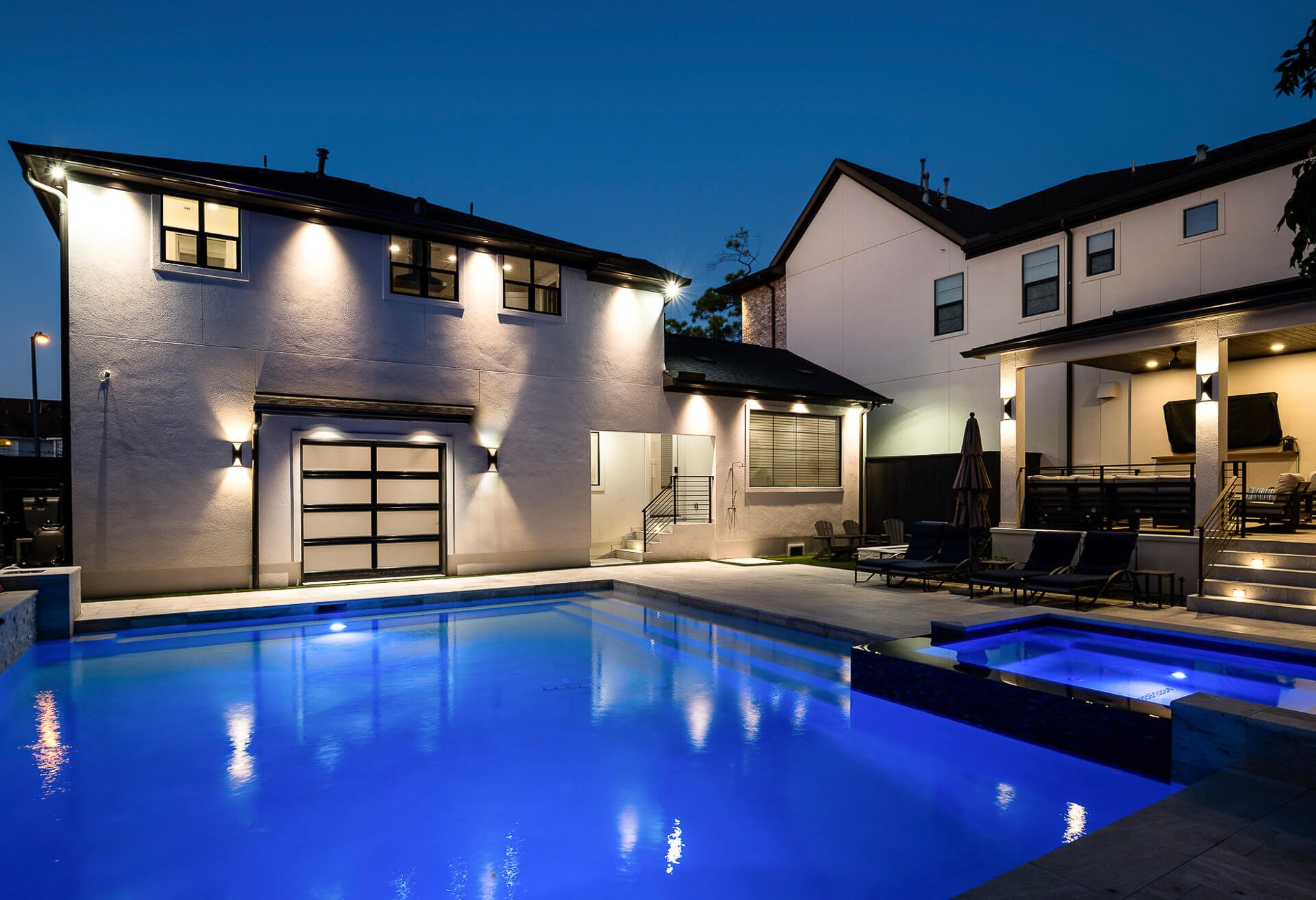Backyard view of a pool house with kitchen windows facing the pool