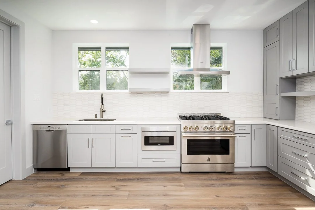 Kitchen range wall with a window behind the hood