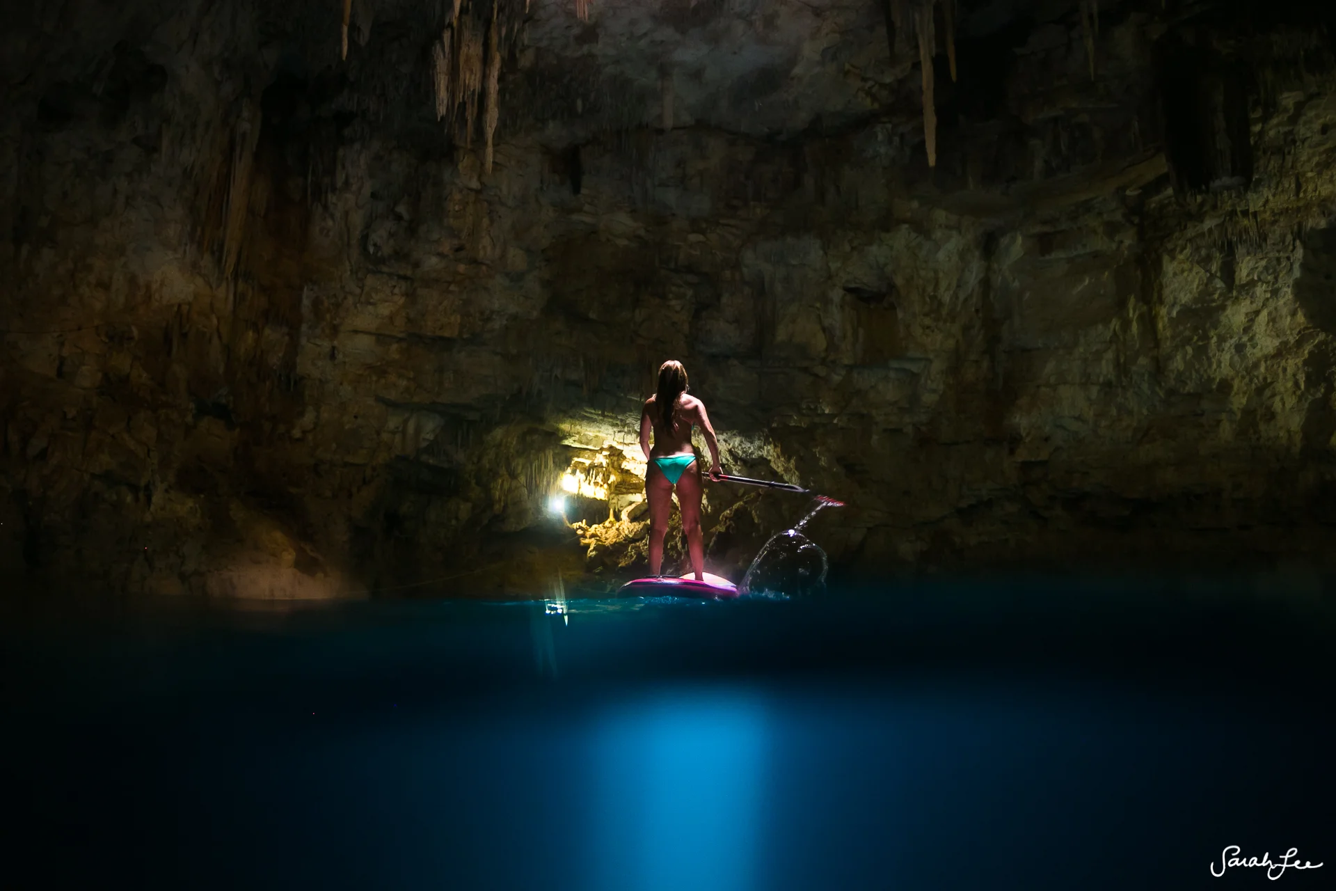 Split-level shot of adventurer Alison Teal in a cenote in Mexico. Taken with the Outex dome port and Canon 16-35mm wide angle lens.